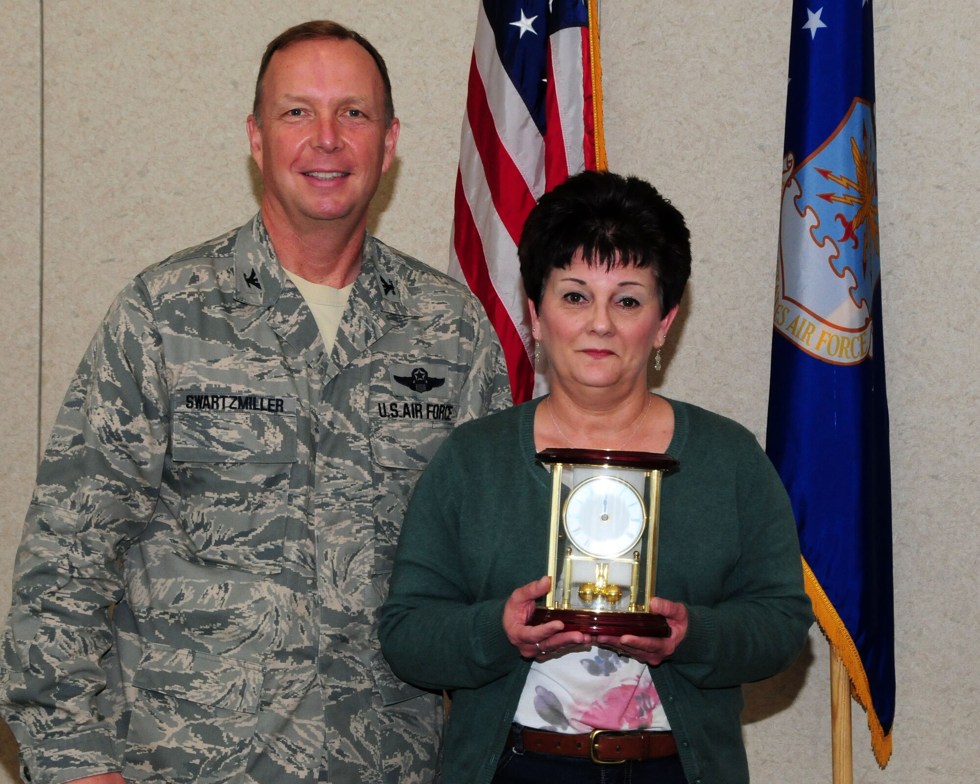 Mrs. Donna Jellison, 914th Force Support Squadron administrative assistant, poses for a photo with Col. Allan Swartzmiller, 914th Airlift Wing commander after receiving the annual 914th Airlift Wing Civilian Award on March 21, 2012 at the Niagara Falls Air Reserve Station, NY.  Jellison was one of several recipients who received an award during a civilian commander's call here. (U.S. Air Force photo by Peter Borys)
