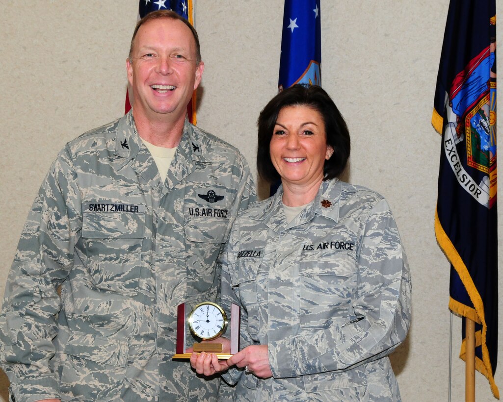 Major Andrea Pitruzzella, 914th Airlift Wing public affairs officer, poses for a photo with Col. Allan Swartzmiller, 914th Airlift Wing commander after receiving the 914th Airlift Wing Semi-Annual Civilian Award on March 21, 2012 at the Niagara Falls Air Reserve Station, NY.  Pitruzzella who is an Air Reserve Technician was one of several recipients who received an award during a civilian commander's call here. (U.S. Air Force photo by Peter Borys)