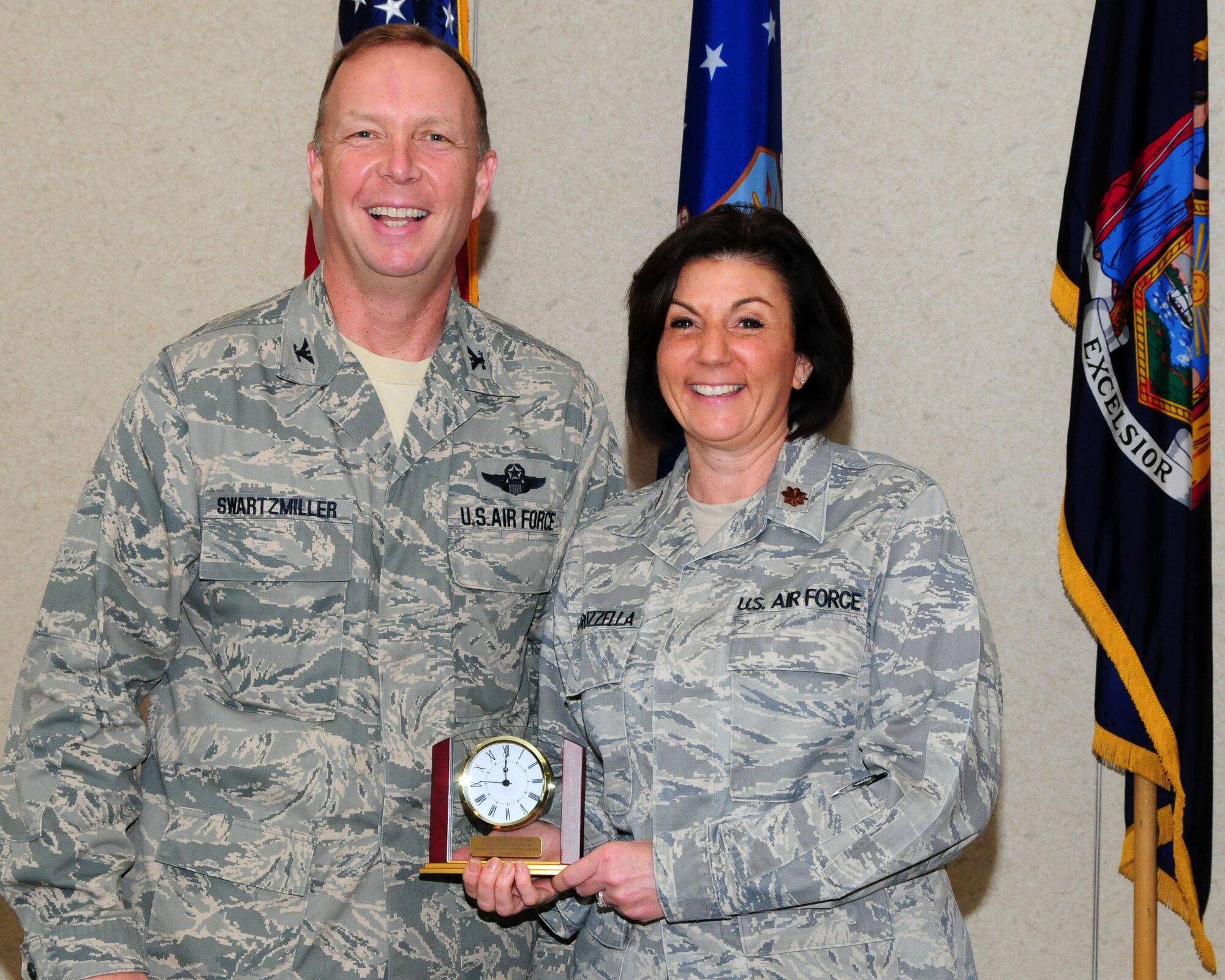 Major Andrea Pitruzzella, 914th Airlift Wing public affairs officer, poses for a photo with Col. Allan Swartzmiller, 914th Airlift Wing commander after receiving the 914th Airlift Wing Semi-Annual Civilian Award on March 21, 2012 at the Niagara Falls Air Reserve Station, NY.  Pitruzzella who is an Air Reserve Technician was one of several recipients who received an award during a civilian commander's call here. (U.S. Air Force photo by Peter Borys)