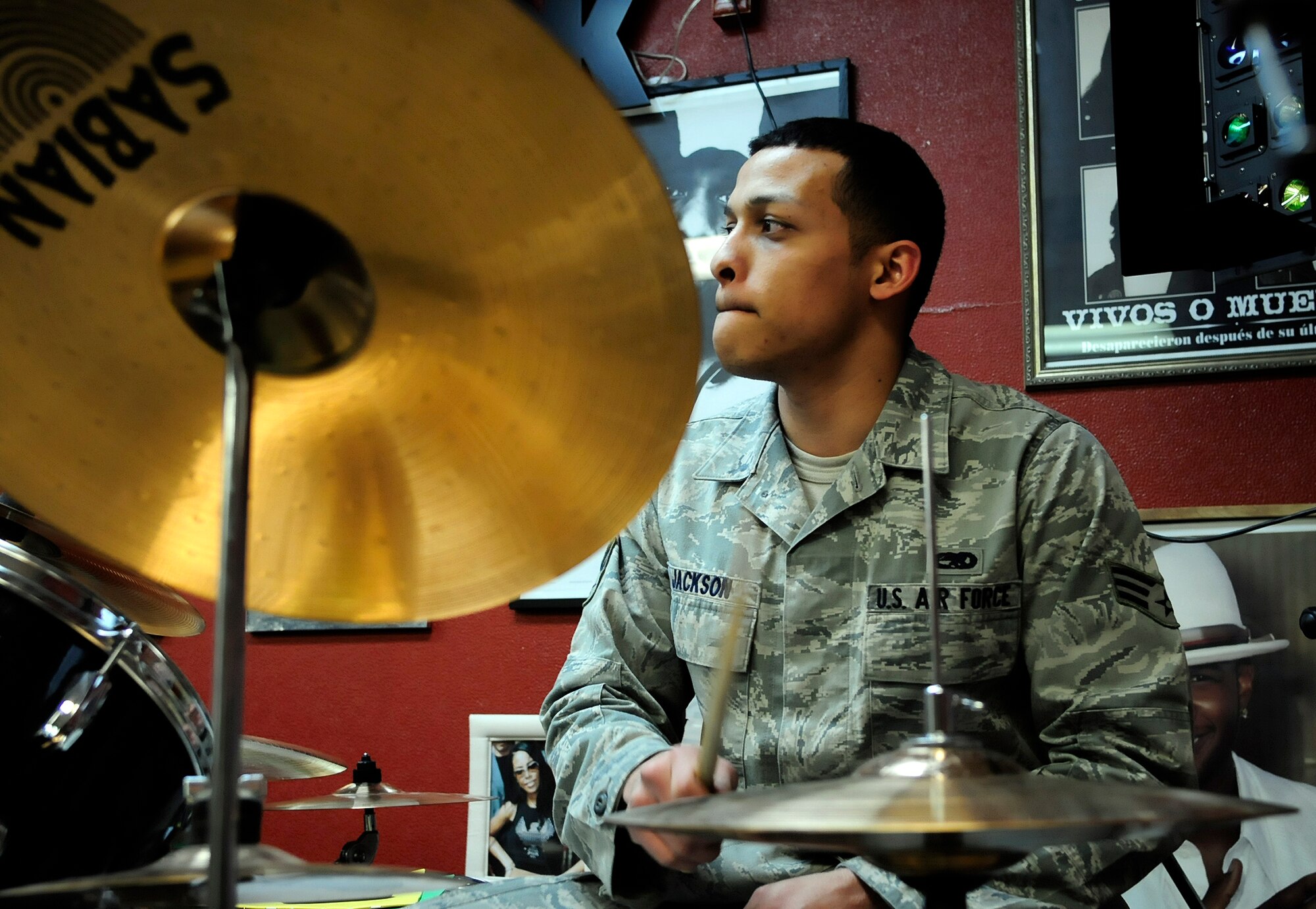 U.S. Air Force Senior Airman Charles Jackson performs a drum fill during a practice with Red Ball at the teen center here March 15, 2012. Jackson is a support technician with the 18th Aircraft Maintenance Unit. (U.S. Air Force photo/Airman 1st Class Zachary Perras)
