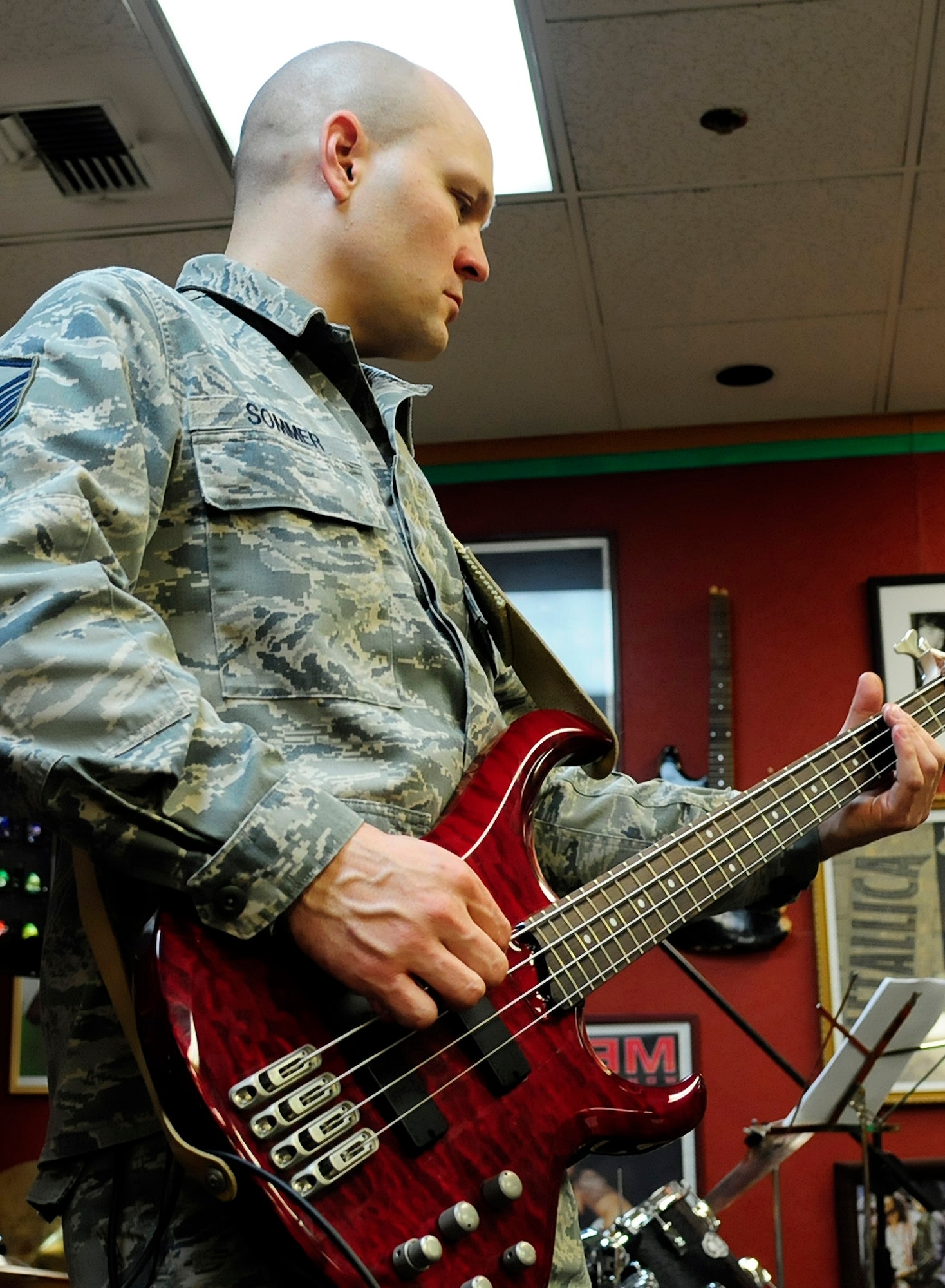 U.S. Air Force Master Sgt. Darrin Sommer, 354th Maintenance Squadron maintenance flight chief, plays bass during a band practice at the teen center here March 15, 2012. Sommer is the bassist of Red Ball, an all-maintenance band. (U.S. Air Force photo/Airman 1st Class Zachary Perras)