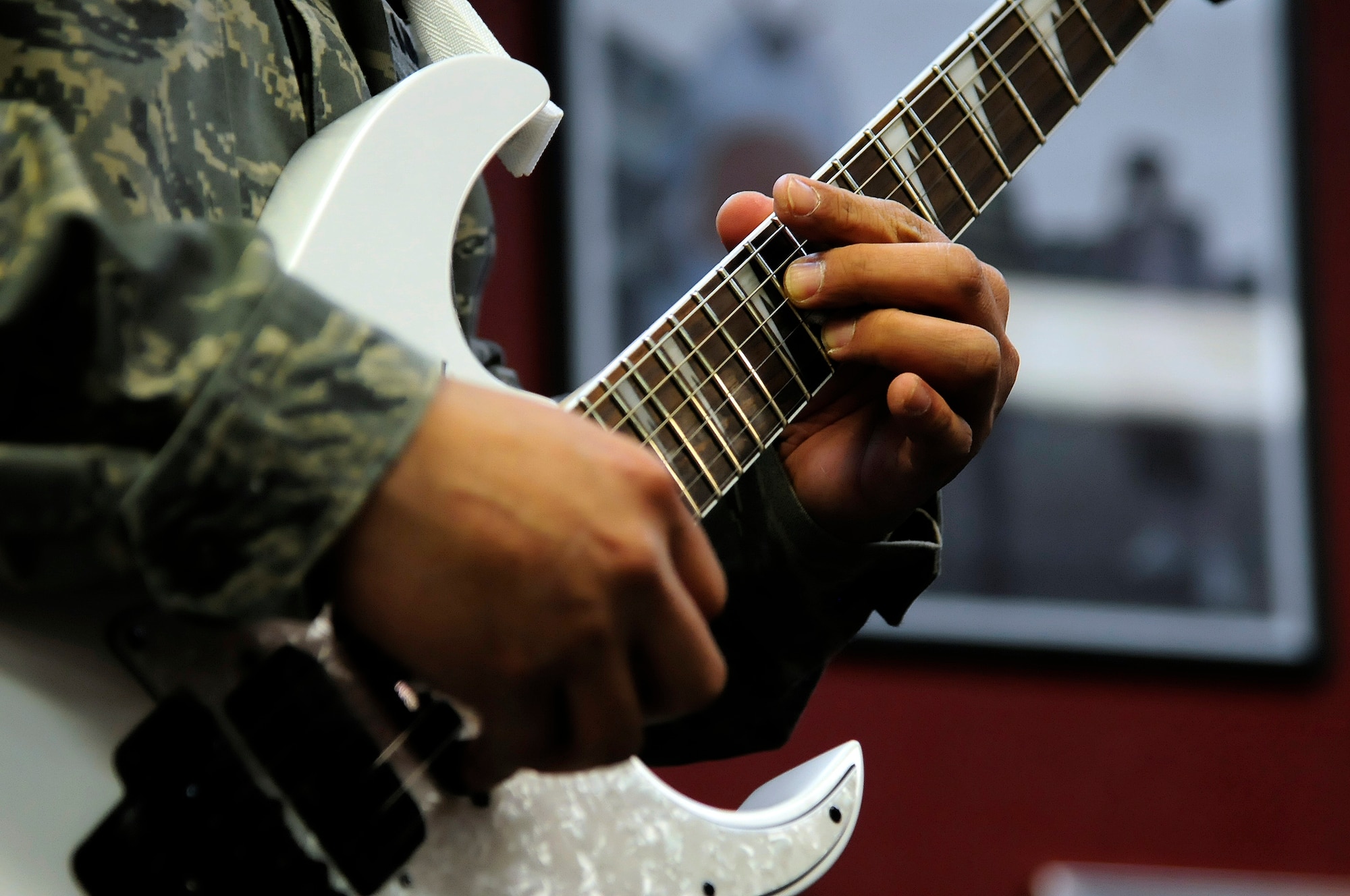 U.S. Air Force Master Sgt. Mauro Ordinario, 354th Maintenance Squadron NCO in charge of plans, scheduling and documentation, improvises a solo during practice with Red Ball, an all-maintenance band, at the teen center here March 15, 2012. Ordinario is the lead guitarist. (U.S. Air Force photo/Airman 1st Class Zachary Perras)