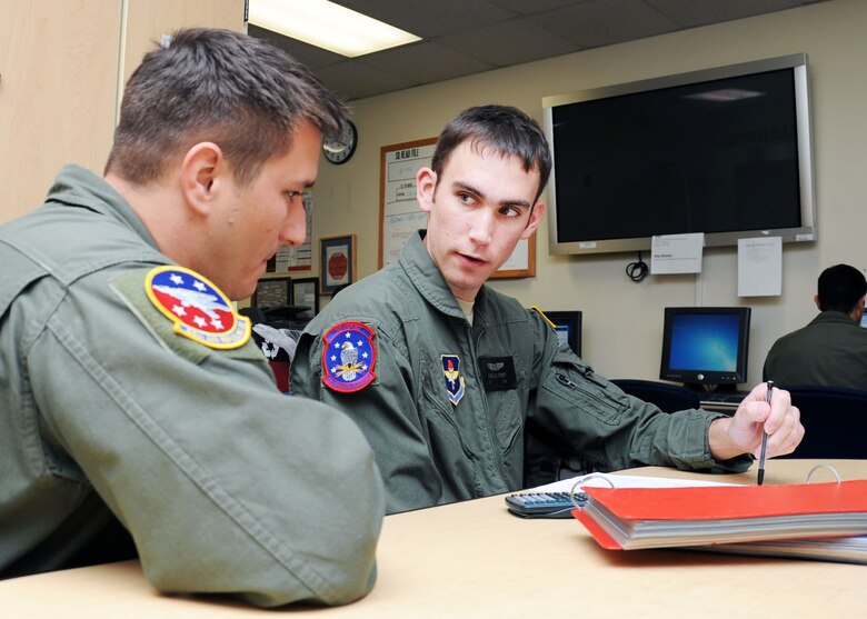 ALTUS AIR FORCE BASE, Okla. – Airman 1st Class Nicholas Roney, 97th Training Squadron boom operator student, goes over pre-flight briefings with Tech. Sgt. Rory Wilcox, 54th Air Refueling Squadron boom operator instructor, at the 54th ARS building Mar. 20, 2012. Roney is the only first-term Airman to go through the boom operator technical school scoring a 100% on every academic test at Altus AFB. (U.S. Air Force photo by Senior Airman Leandra D. Stepp / 97th Air Mobility Wing Public Affairs / Released) 