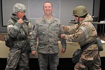 Master Sgt. Kevin Bradt has his senior master sergeant stripes tacked on by Col. Patrick Doherty and Chief Master Sgt. Blake Malpass during exercise Coronet Warrior 20-12 at Seymour Johnson Air Force Base, N.C. Bradt and wife Tanica were two of 18 Airmen from the wing selected for promotion to senior master sergeant. Bradt is the 4th Logistics Readiness Squadron superintendent of the Deployment and Distribution Flight. (U.S. Air Force photo/Staff Sgt. Courtney Richardson/Released)