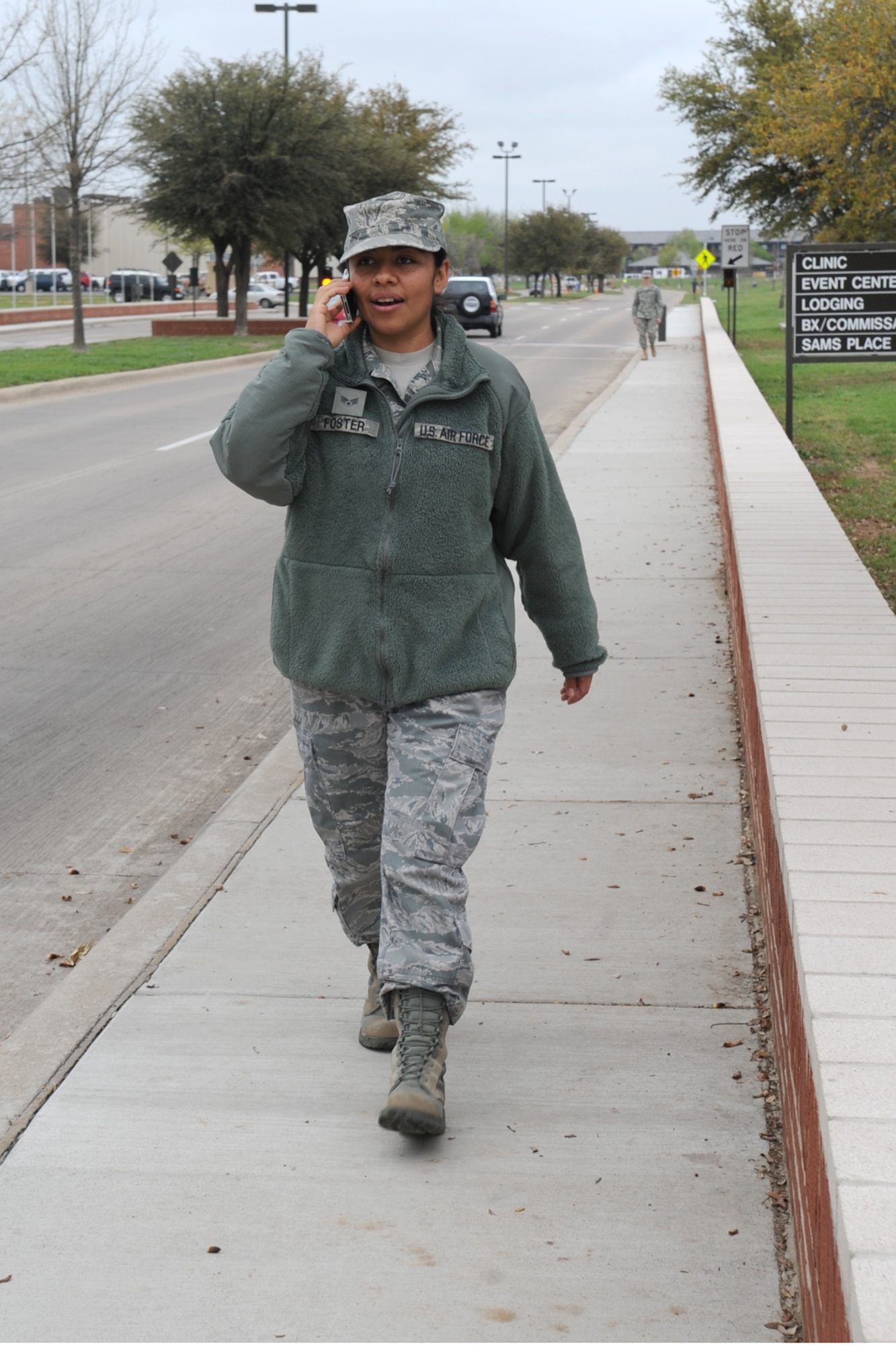 GOODFELLOW AIR FORCE BASE, Texas -- Senior Airman Nancy Foster, 17th Security Forces Squadron, demonstrates what not to do when walking with a cell phone, March 14. According to AFI 36-2903 Dress and Personal Appearance of Air Force Personnel paragraph 6.3.3.2., while walking in uniform use of personal electronic media devices, including ear pieces, speaker phones or text messaging is limited to emergencies or when official notifications are necessary. Military customs and courtesies take precedence. (U.S. Air Force photo/Staff Sgt. Laura R. McFarlane)