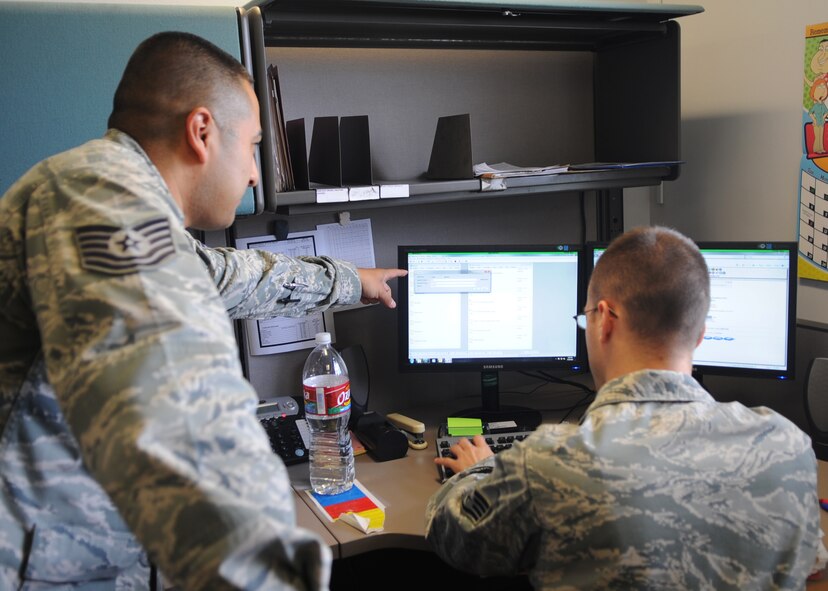 Tech. Sgt. David Alvarez, left, 7th Contracting Squadron, goes over the contract writing system with Staff Sgt. Kyle Kinder, right, 7th CONS March 20, 2012, at Dyess Air Force Base, Texas. 7th CONS works with different contractors throughout the base as well the local community. (U.S. Air Force photo by Airman 1st Class Cierra Bullock/ Released) 