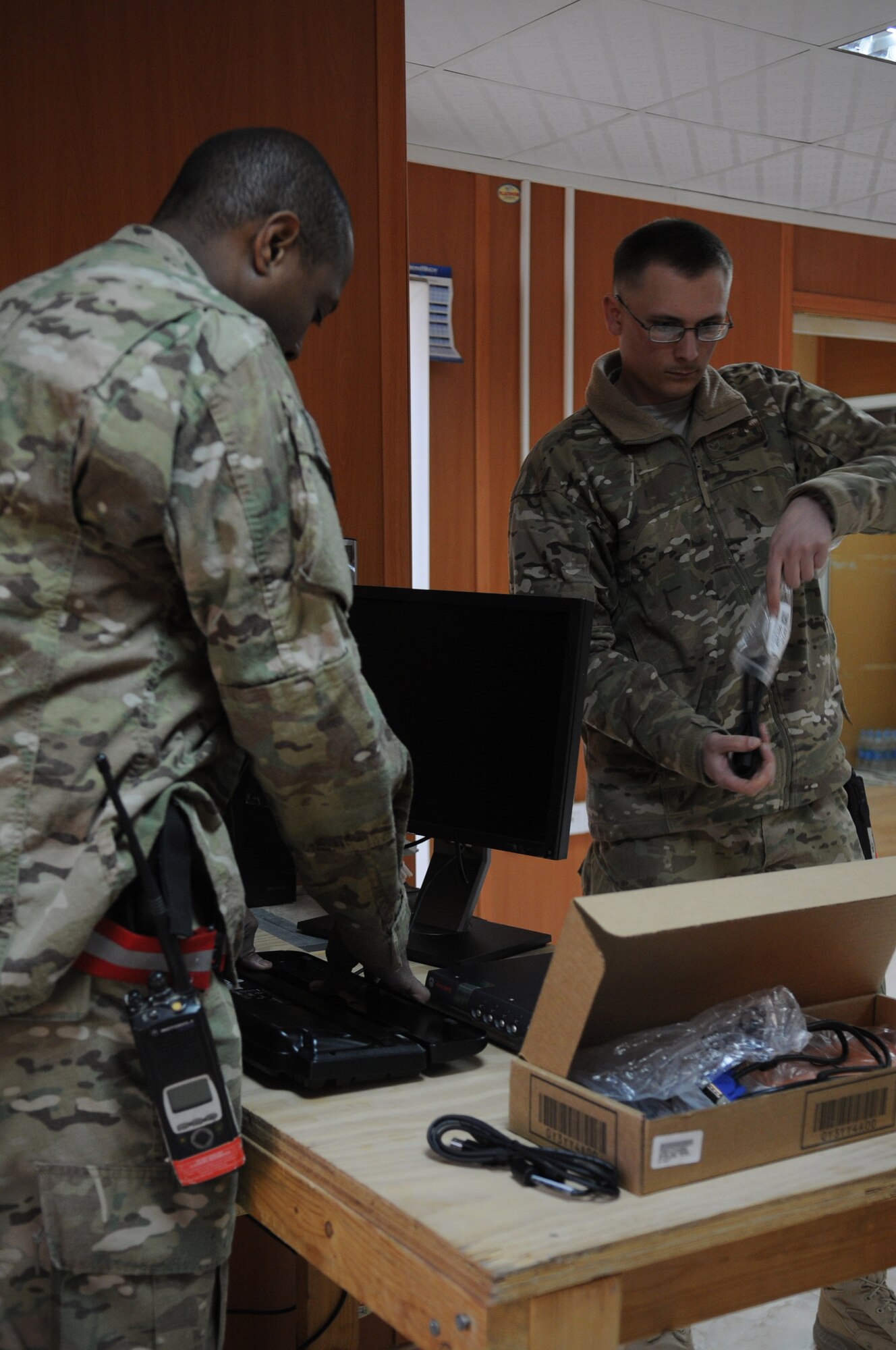 Tech. Sgt. Tommy Nixon and Senior Airman Adam Westcott, client systems technicians with the 445th Air Expeditionary Advisory Squadron, unpack and setup new computer assets to be used at a newly created English language immersion center, Shindand Air Base, Afghanistan, March 20, 2012. Nixon and Wade are assigned to the 445th AEAS as part of the communications sustainment team that manage all communication capabilities of the 838th Air Expeditionary Group advisors. (U.S. Air Force photo by Staff Sgt. Nadine Y. Barclay)