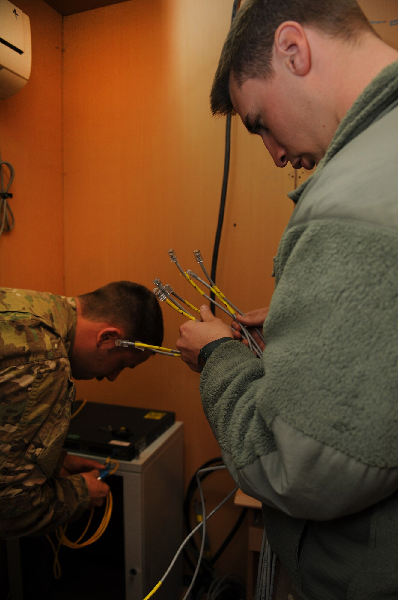 Staff Sgt. Brian McGahey and Senior Airman Patrick Wade, network infrastructure technicians with the 445th Air Expeditionary Advisory Squadron, set up a network server for a newly created English language immersion center, Shindand Air Base, Afghanistan, March 20, 2012. Both McGahey and Wade are assigned to the 445th AEAS as part of the communications sustainment team that manage all communication capabilities of the 838th Air Expeditionary Group advisors. (U.S. Air Force photo by Staff Sgt. Nadine Y. Barclay)