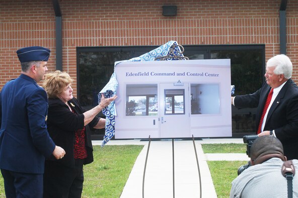 Ginger Edenfield unveils the new name of the command post. The Edenfield Command and Control Center is named after her late husband Col. Billy G. Edenfield. (U. S. Air Force photo by Sue Sapp)