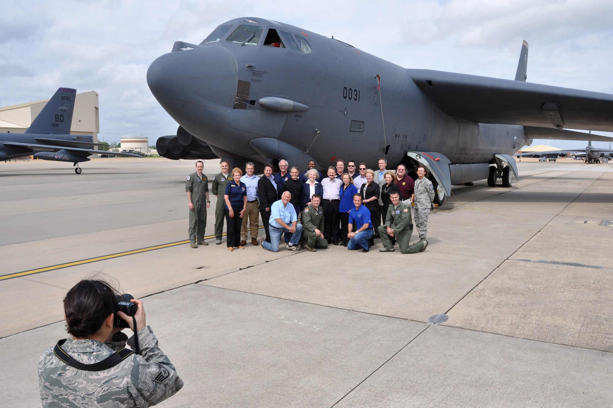 Staff Sgt. Jenny Chamberlin, a public affairs representative assigned to the 927th Air Refueling Wing, MacDill Air Force Base, Fla., takes a photo of a group of Florida civic leaders during their tour of Barksdale. (U.S. Air Force photo by Master Sgt. Jeff Walston/Released)