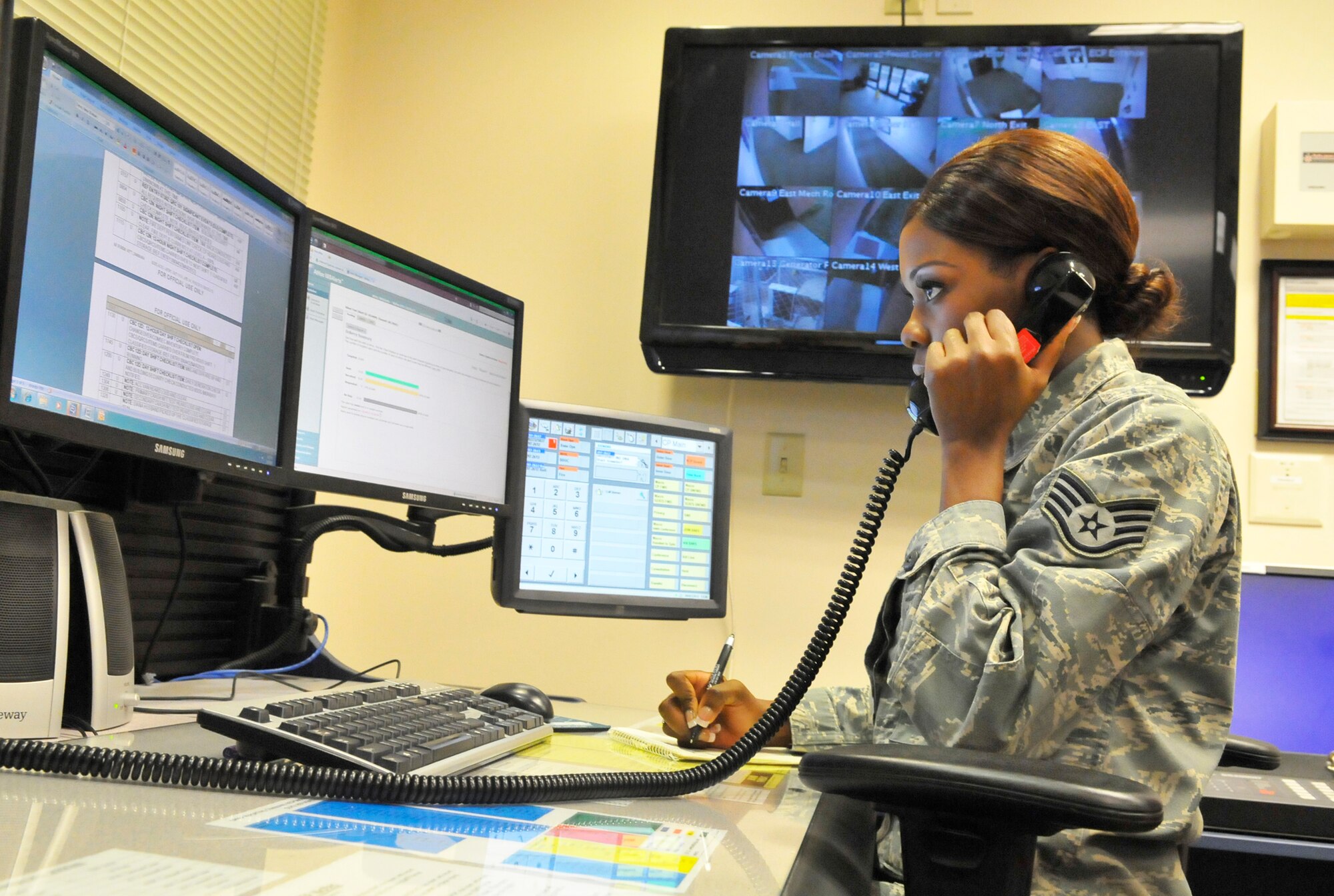 Staff Sgt. Meranda Lee, 78th Air Base Wing Command Post emergency action controller, answers a call in the command post. (U. S. Air Force photo by Sue Sapp)