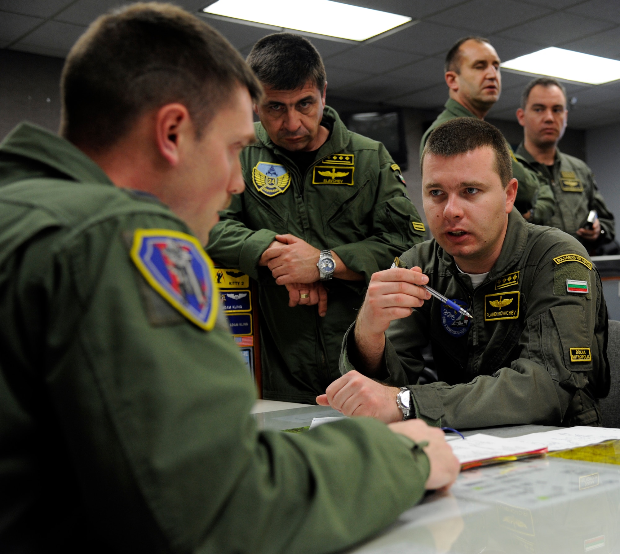 LAUGHLIN AIR FORCE BASE, Texas – Capt. Plamen Kovachev, an instructor pilot, and Capt. Aleksandar Slavchev, a helicopter squadron commander, both with the Bulgarian Air Force ask an instructor pilot questions after observing student pilots in class here March 19. Radev and his accompanying officers visited Laughlin as part of a series of base visits designed to highlight the U.S. Air Force’s pilot training program and aid in Bulgarian Air Force pilot training reform. (U.S. Air Force photo/Airman 1st Class Nathan L. Maysonet)