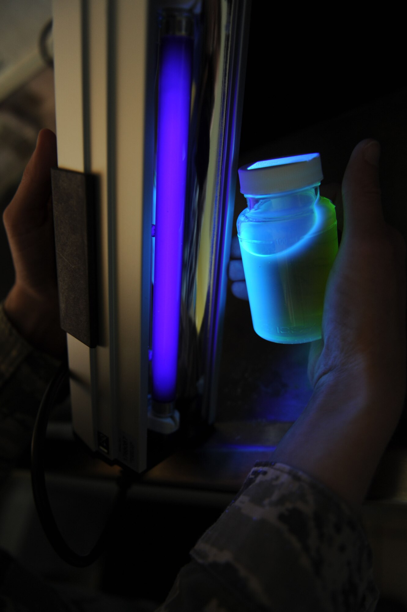 SPANGDAHLEM AIR BASE, Germany – Staff Sgt. Eva Doty, 52nd Aerospace Medicine Squadron water protection program NCO in charge, uses a black light to check a water sample at Bldg. 175 here March 20 for florescence to ensure no harmful bacteria is in the base water system. Samples are taken at 21 different locations around base every month. The amount of samples taken per month is based on governing standards as well as the base population. The Airmen provide emergency response capability, monitor drinking water, assess chemical and noise hazards, and protect the environment against contamination from accidental releases of hazardous materials. (U.S. Air Force photo by Senior Airman Christopher Toon/Released)