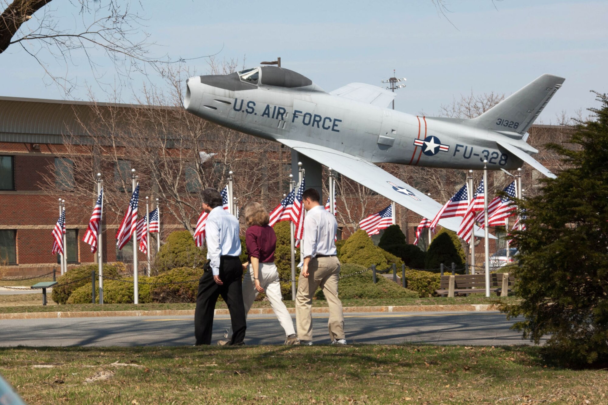 HANSCOM AIR FORCE BASE, Mass. – Base personnel enjoy the nice weather by taking a walk near the F-86 static display March 19. Spring officially arrived March 20 and with it came warmer temperatures. (U.S. Air Force photo by Linda LaBonte Britt) 