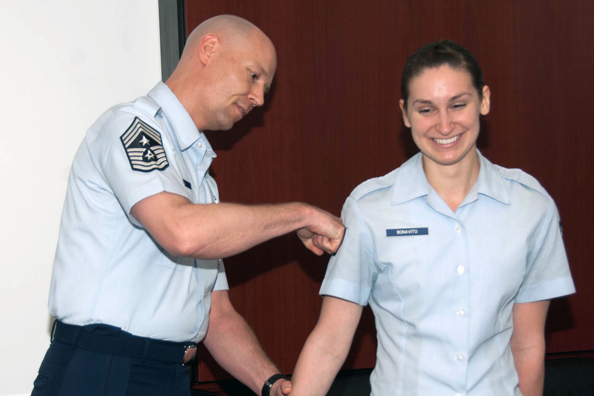 HANSCOM AIR FORCE BASE, Mass. – Chief Master Sgt. Kevin Call (left), Electronic Systems Center command chief, tacks senior airman stripes on Airman 1st Class Michelina Bonavito March 19. Bonavito was awarded Senior Airman Below-the-Zone. (U.S. Air Force photo by Linda LaBonte Britt)