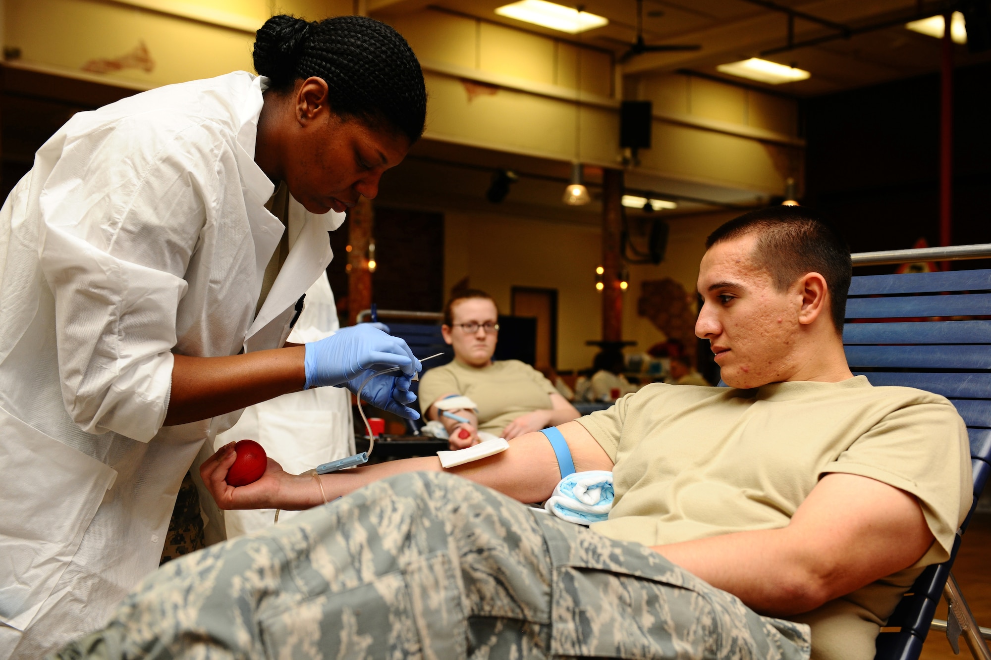 SPANGDAHLEM AIR BASE, Germany – Army Spc. Clarissa Parker, Landstuhl Regional Medical Center medical lab technician, prepares to draw blood from Air Force Senior Airman Michael Kimball, 480th Fighter Squadron intelligence analyst, during the Spangdahlem Community Blood Drive at the Brick House here March 21. Spangdahlem members donated blood to the Armed Services Blood Program which distributes blood products to service members and their families around the world. (U.S. Air Force photo by Airman 1st Class Matthew B. Fredericks/Released)