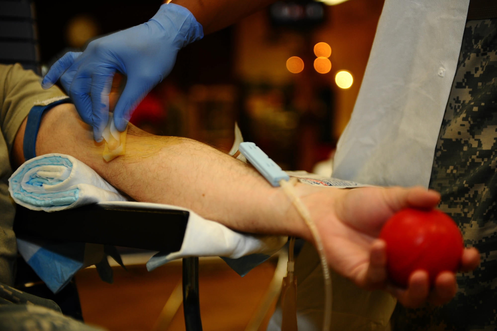 SPANGDAHLEM AIR BASE, Germany – A Landstuhl Regional Medical Center medical lab technician spreads iodine on the arm of a donor to sterilize the area during the Spangdahlem Community Blood Drive at the Brick House here March 21. Spangdahlem members donated blood to the Armed Services Blood Program, which distributes blood products to service members and their families around the world. (U.S. Air Force photo by Airman 1st Class Matthew B. Fredericks/Released)