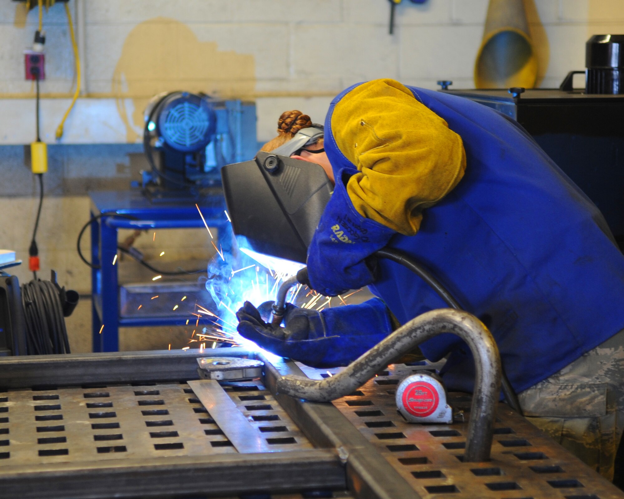 Airman 1st Class Brooke Goosen, 7th Equipment Maintenance Squadron, welds on a piece of damaged equipment March 20, 2012, at Dyess Air Force Base, Texas.  Goosen is the only female in the welding shop at Dyess. (U.S. Air Force photo by Airman 1st Class Cierra Bullock/Released)