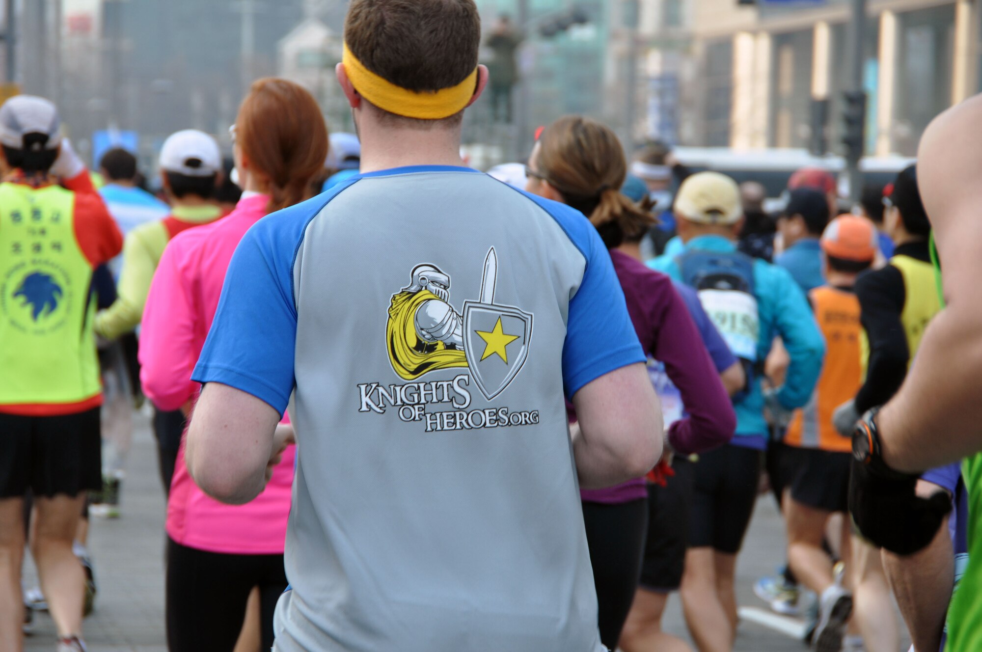 Runners from Osan and Kunsan Air Bases wear T-shirts with the Knights of Heroes emblem during the Seoul Marathon, March 18, 2012. The Knights of Heroes Foundation provides programs for children who have lost their fathers in combat (U.S. Air Force photo/1st Lt. Sara B. Greco)