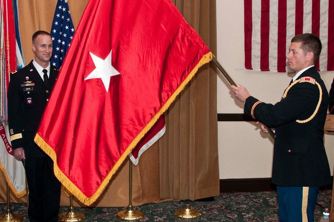 SAN FRANCISCO — Capt. Chris Herold unfurls the one-star-flag of Brig. Gen. Mike Wehr at a Frocking Ceremony March 15, 2012. Wehr is the U.S. Army Corps of Engineers South Pacific Division Commander