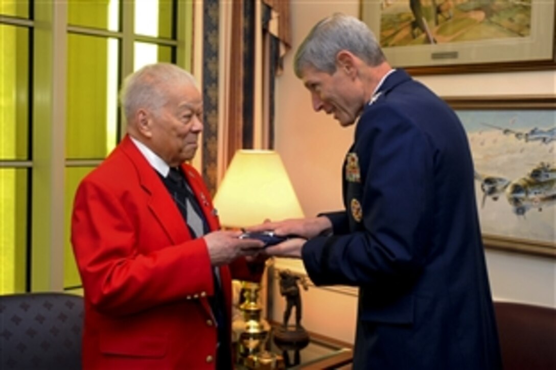 U.S. Air Force Chief of Staff Gen. Norton Schwartz, presents an American flag that was flown over the Pentagon to Tuskegee Airman, retired Lt. Col. Walter McCreary. Schwartz hosted an office call in  McCreary's honor in the Pentagon, March 16, 2012.