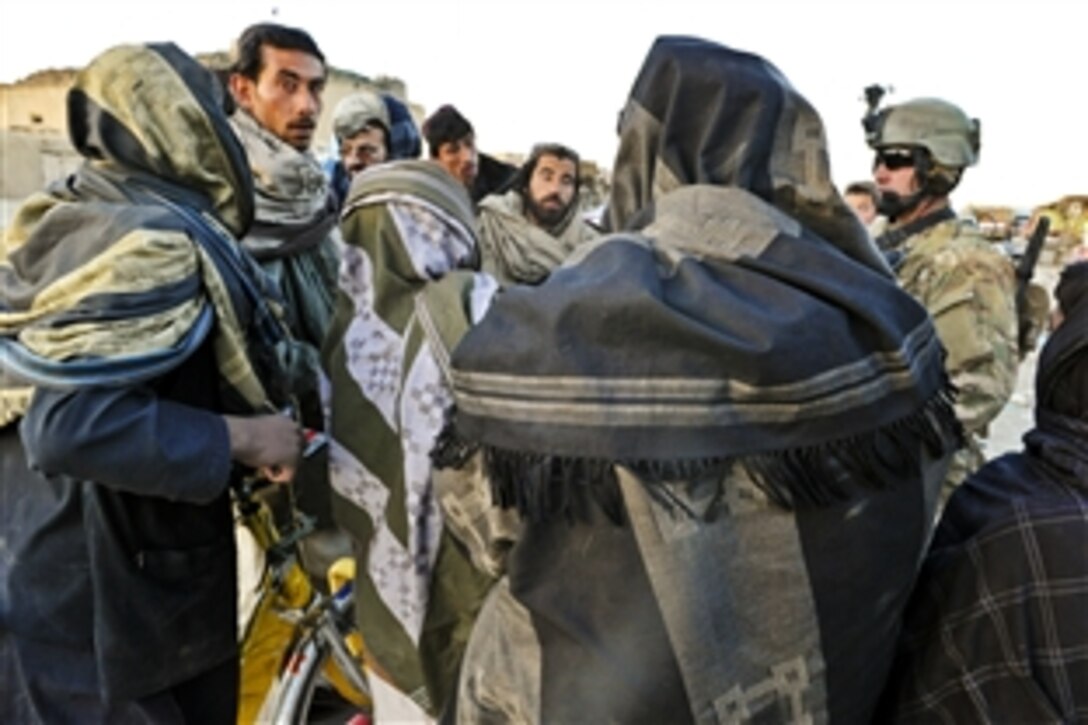 Coalition forces talk to merchants about recent attacks by insurgents during a patrol in the Muqer district in Afghanistan's Ghazni province, March 21, 2012. Coalition forces conducted the patrol to engage merchants, villagers and key leaders in the area.