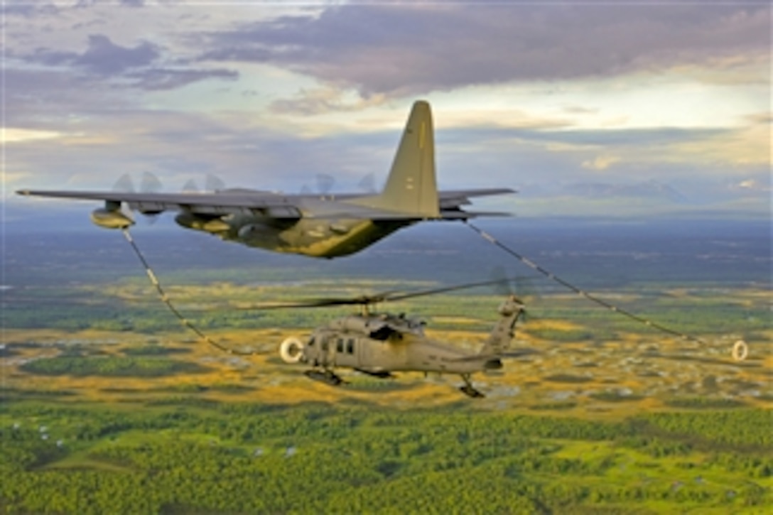 An Alaska Air National Guard HC-130 aircraft and HH-60 Pave Hawk helicopter practice helicopter aerial refueling over Joint Base Elmendorf-Richardson, Alaska, on March 14, 2012.  