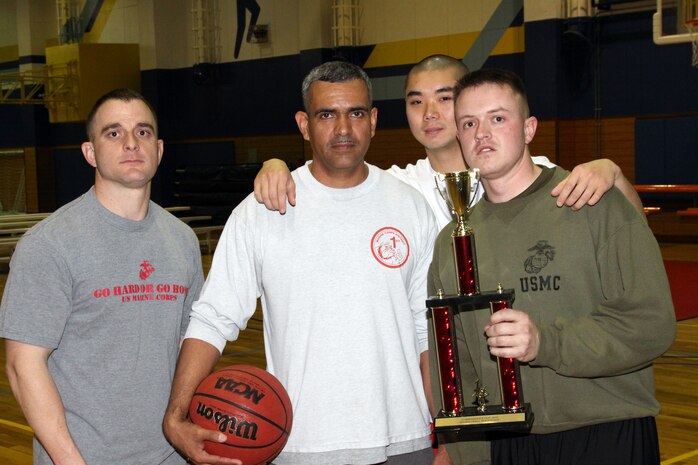 (Left to right) Staff Sgt. Chowa Pearson, Sgt. Maj. Albert Diaz, Lt. j. g. Alexander Cho and Cpl. Eric Holz, Marine Wing Support::r::::n::Squadron servicemembers and winners of the Commander’s Cup three point shoot out competition, held at IronWorks Gym sports courts here March 23. The MWSS-171 scored a total of 114 points durring the cometition.