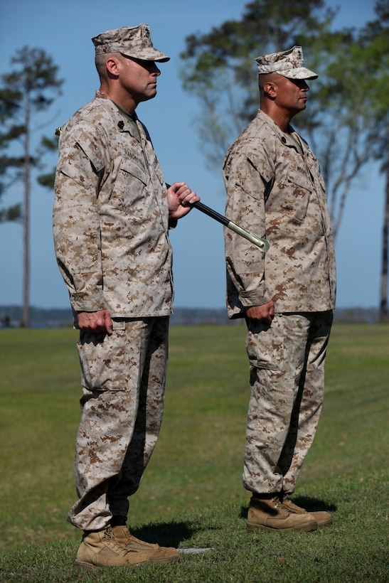 Sgt. Maj. Robert G. VanOostrom, who served as sergeant major for Marine Corps Installations East from August 2009 to March 2012, prepares to hand over the Sword of Office to Sgt. Maj. Ernest K. Hoopii, the new sergeant major for MCIEAST in a ceremony at Marine Corps Base Camp Lejeune.