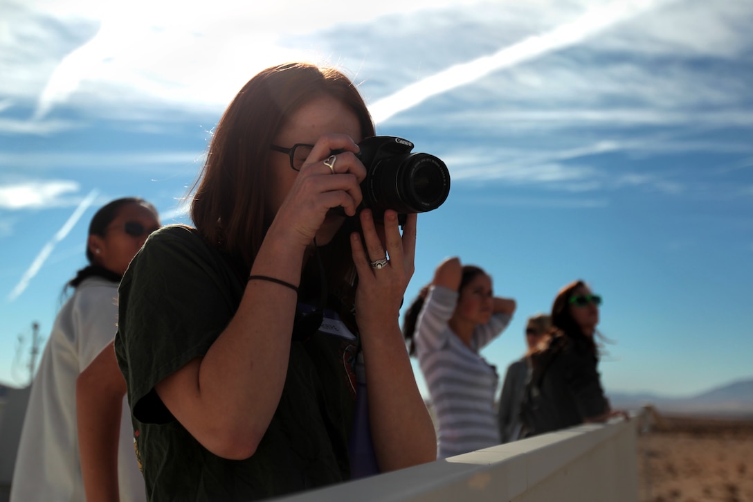 Nicole Thorpe, wife of Cpl. Joshua Thorpe, mortarman, Weapons Co., 2nd Battalion, 7th Marine Regiment, takes a picture of Marines conducting a counter improvised explosive device course during 2/7’s Field Safari at Range 800 March 23, 2012.::r::::n::