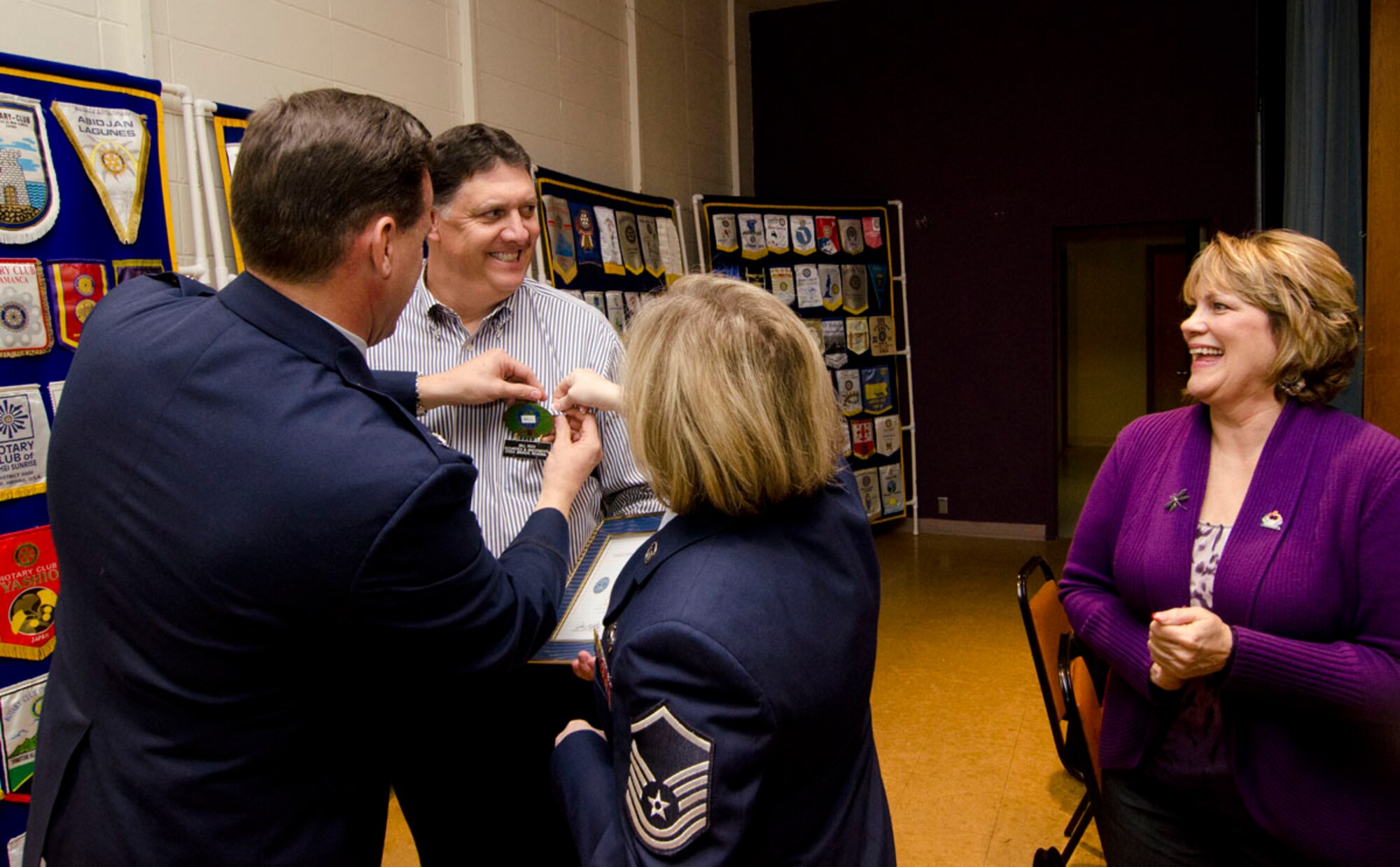William Rich, a founding partner of Asset Management Group in Chico, Calif., receives the Employer Support of the Guard and Reserve Patriot Award from 940th Wing Commander, Col. Kevin Cavanagh, and Master Sgt. Kelly Derrington as his wife, Paula Coleman-Rich, looks on during the January meeting of the Chico Rotary Club.. Derrington, Rich's executive assistant and a 940th Wing Reservist, submitted her civilian employer for the award that recognizes employers who go "above and beyond" in their support of an employee's participation in the Guard and Reserves. (Courtesy photo) 