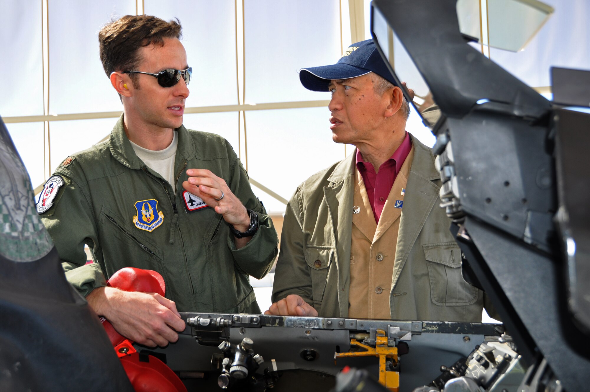 Maj Justin Robinson, 69th Fighter Squadron pilot explains the control panel of an F-16 to Ambassador Sichan Siv during his recent visit. Ambassador Siv was part of a group of San Antonio civic leaders and Reservist from the 433rd Airlift Wing, Lackland Air Force Base Texas, who visited Luke Air Force Base, Ariz., Thursday. The group of 23 arrived on a C-5A and spent the day touring Luke AFB, including a visit to the 308th Fighter Squadron and “training” in the F-16 simulators. The civic leaders were on a two day tour of Arizona bases with their second stop scheduled for Davis-Monthan Air Force Base in Tucson, Ariz.  The tour was part of the 433rd Airlift Wing’s community outreach program to increase community partners’ awareness of the U.S. Air Force Reserve mission.  (U.S. Air Force photo by Staff Sgt. Denise Willhite)