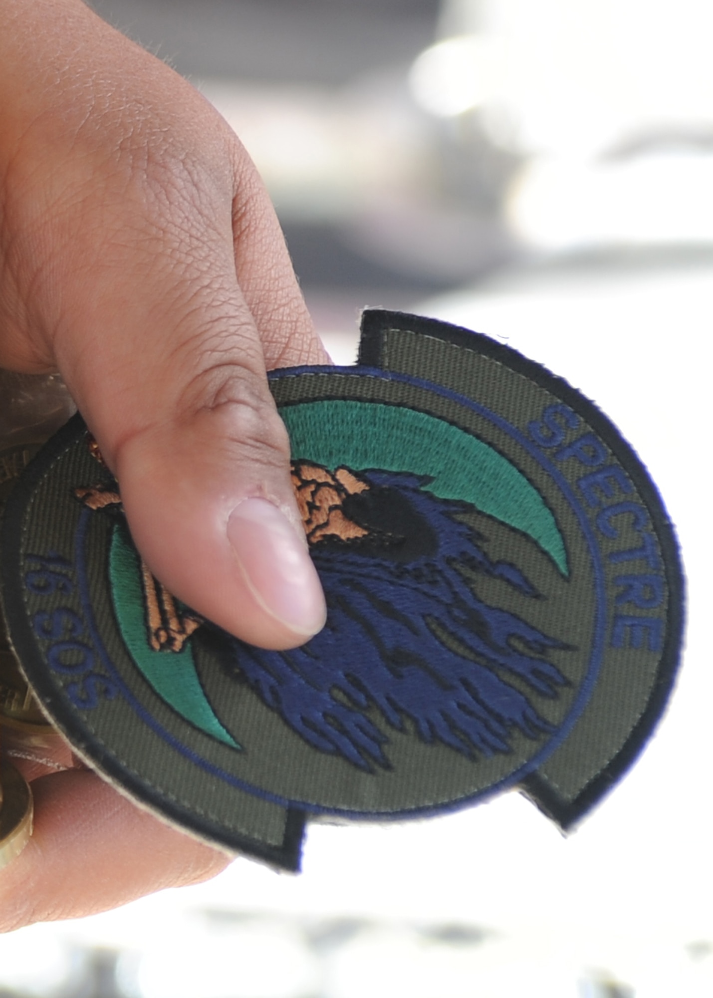 U.S. Army veteran Wesley Leon-Barrientos holds a squadron patch given to him by a crew from the 16th Special Operations Squadron at Cannon Air Force Base, N.M. , March 22, 2012. The Spectre has been a symbol of the 16 SOS and the AC-130H Spectre gunship since the Vietnam War. (U.S. Air Force photo by Airman 1st Class Eboni Reece)