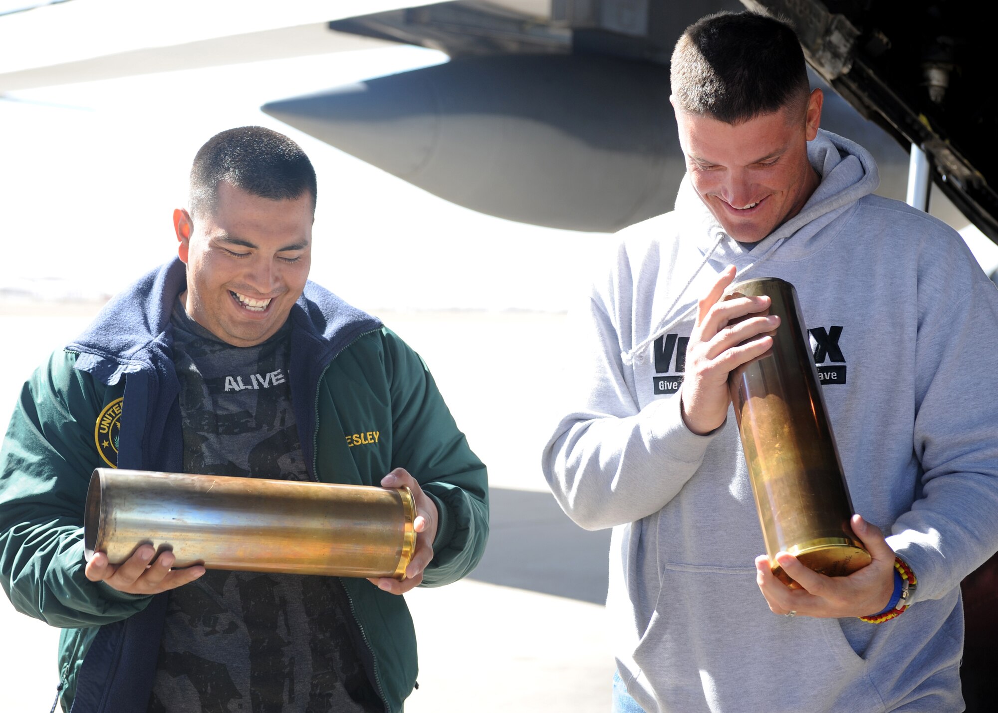 U.S. Army veteran Wesley Leon-Barrientos and U.S. Marine Corps Jeremy Staat admire 105 mm shell casings given to them by the crew from the 16th Special Operations Squadron at Cannon Air Force Base, N.M., March 22, 2012. Leon-Barrientos and Staat are doing a coast-to-coast bike ride to unite veterans and raise awareness for suicide prevention. (U.S. Air Force photo by Airman 1st Class Eboni Reece)