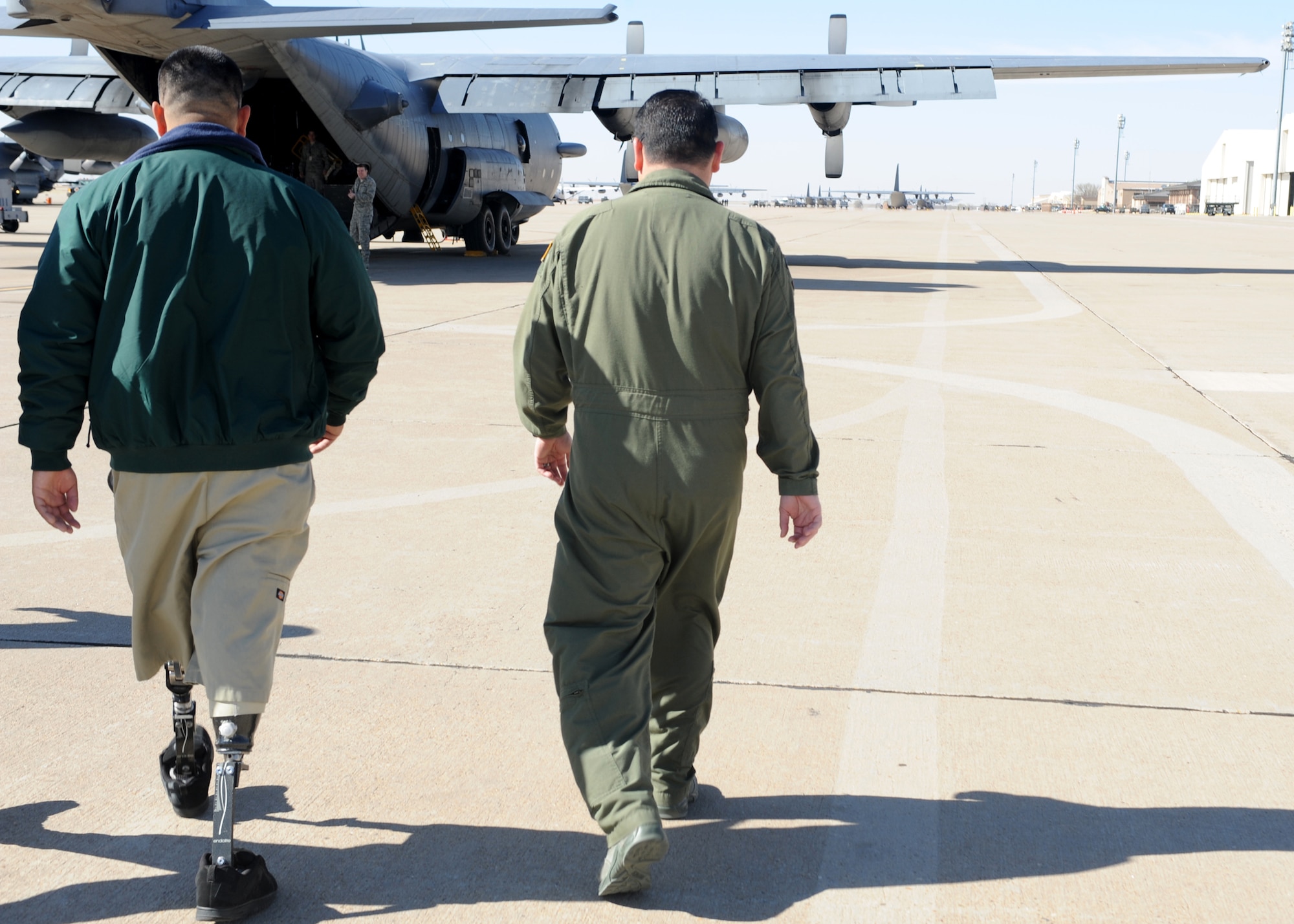 U.S. Army veteran Wesley Leon-Barrientos and U.S. Air Force Master Sgt. Jake Murphy, 16th Special Operations Squadron C-Flight superintendent , walk toward the AC-130H Spectre gunship at Cannon Air Force Base, N.M., March 22, 2012. Leon-Barrientos served with the 101st Airborne Division as an infantryman. (U.S. Air Force photo by Airman 1st Class Eboni Reece)