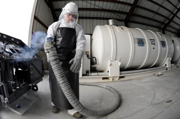U.S. Air Force Staff Sgt. Dustin Volpi, 354th Logistics Readiness Squadron fuels distribution supervisor, issues liquid nitrogen to a liquid nitrogen cart March 20, 2012, Eielson Air Force Base, Alaska. Liquid nitrogen can temporarily shrink mechanical components during machine assembly to perform press fits -- the process of fastening two parts by friction. (U.S. Air Force photo/Staff Sgt. Jim Araos)