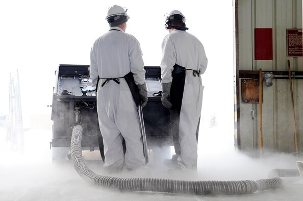 354th Logistics Readiness Squadron cryogenics technicians service a liquid nitrogen cart March 20, 2012, Eielson Air Force Base, Alaska. Aircraft maintainers use the carts to service F-16 Fighting Falcon emergency power units, which serve as an emergency source of electrical and hydraulic power in the event onboard generators or the engine fails. (U.S. Air Force photo/Staff Sgt. Jim Araos)