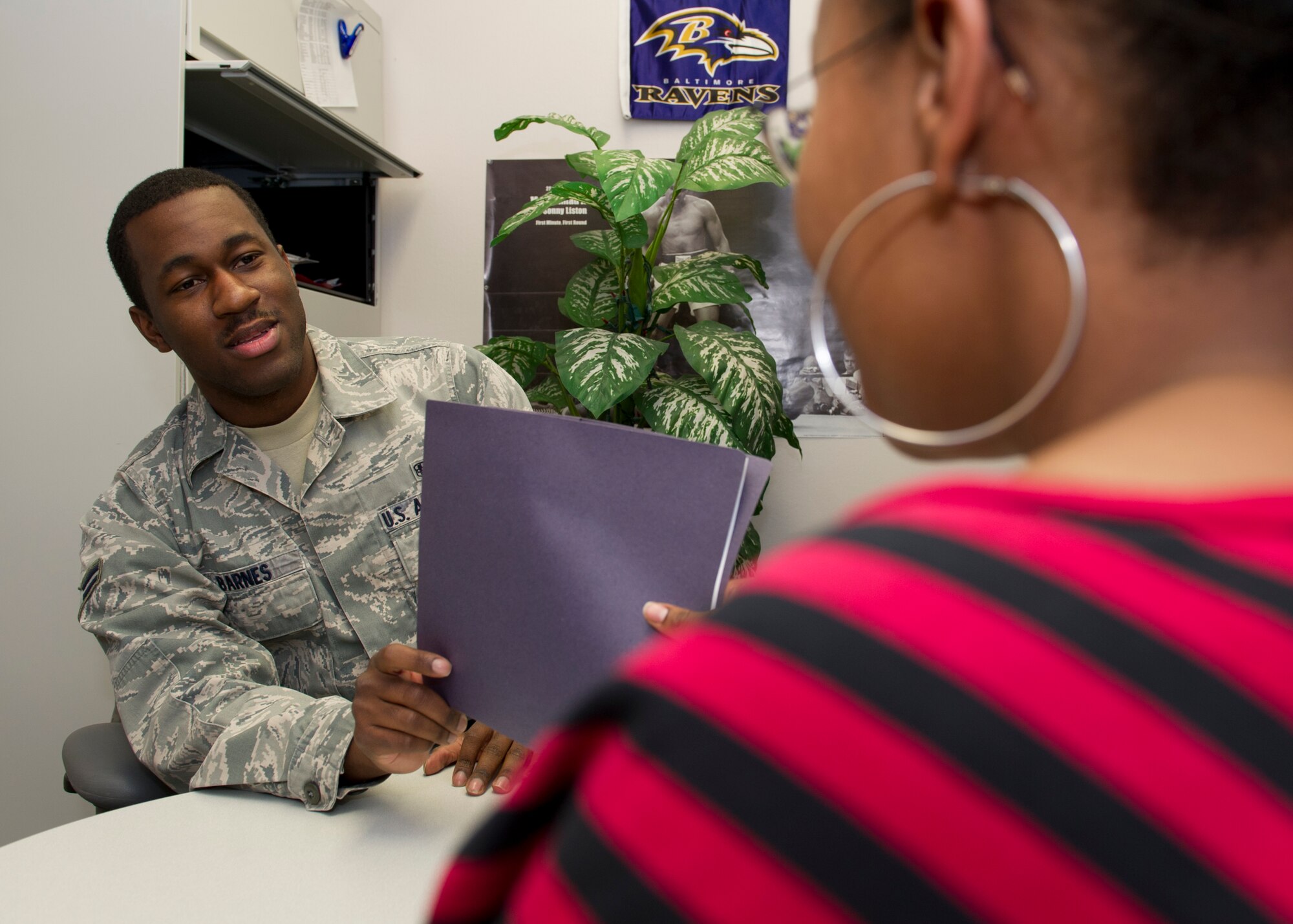 HOLLOMAN AIR FORCE BASE, N.M. – Airman 1st Class Allen Barnes, 49th Medical Support Squadron physical evaluation board liaison officer, gives a patient information on how a Medical Evaluation Board works and what to expect March 22. Barnes was awarded the 49th Medical Group Sharp Airman Award for February. The individual’s supervisor nominates the member then a panel of senior non-comissioned officers looks for the best in job performance, on and off duty education, and fitness. (U.S. Air Force photo by Senior Airman Kasey Close/Released)