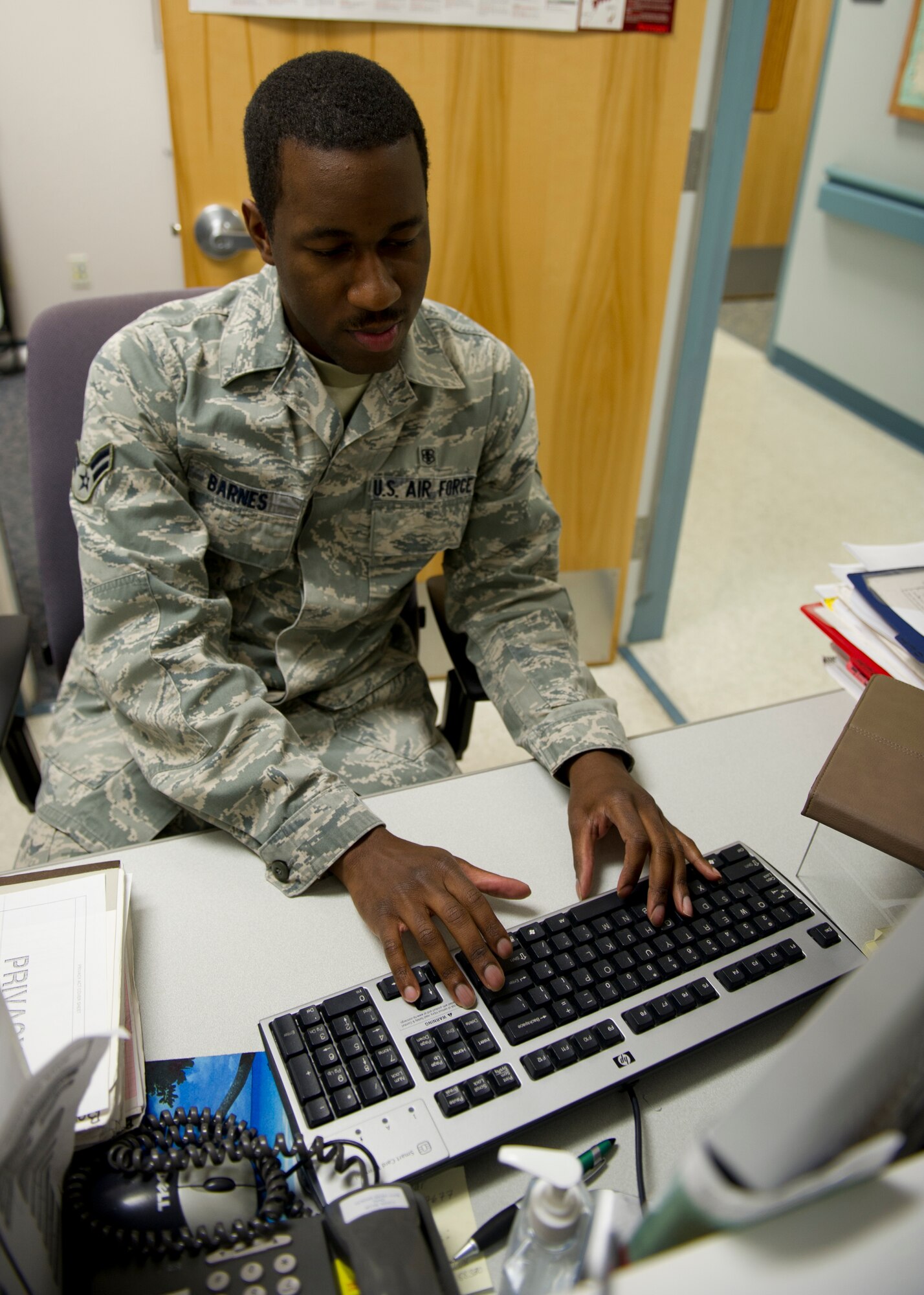 HOLLOMAN AIR FORCE BASE, N.M. – Airman 1st Class Allen Barnes, 49th Medical Support Squadron physical evaluation board liaison officer, enrolls a new patient into Tricare at the medical clinic March 22. Barnes was awarded the 49th Medical Group Sharp Airman Award for February. The individual’s supervisor nominates the member then a panel of senior non-comissioned officers looks for the best in job performance, on and off duty education, and fitness. (U.S. Air Force photo by Senior Airman Kasey Close/Released)
