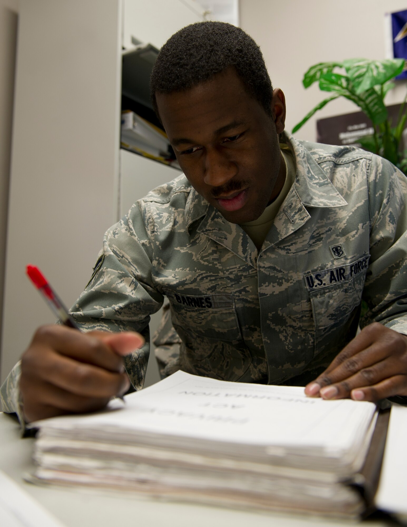 HOLLOMAN AIR FORCE, N.M. – Airman 1st Class Allen Barnes, 49th Medical Support Squadron physical evaluation board liaison officer, gathers information from a patient’s medical record for a Medical Evaluation Board at the medical clinic March 22. Barnes was awarded the 49th Medical Group Sharp Airman Award for February. The individual’s supervisor nominates the member then a panel of senior non-comissioned officers looks for the best in job performance, on and off duty education, and fitness. (U.S. Air Force photo by Senior Airman Kasey Close/Released)