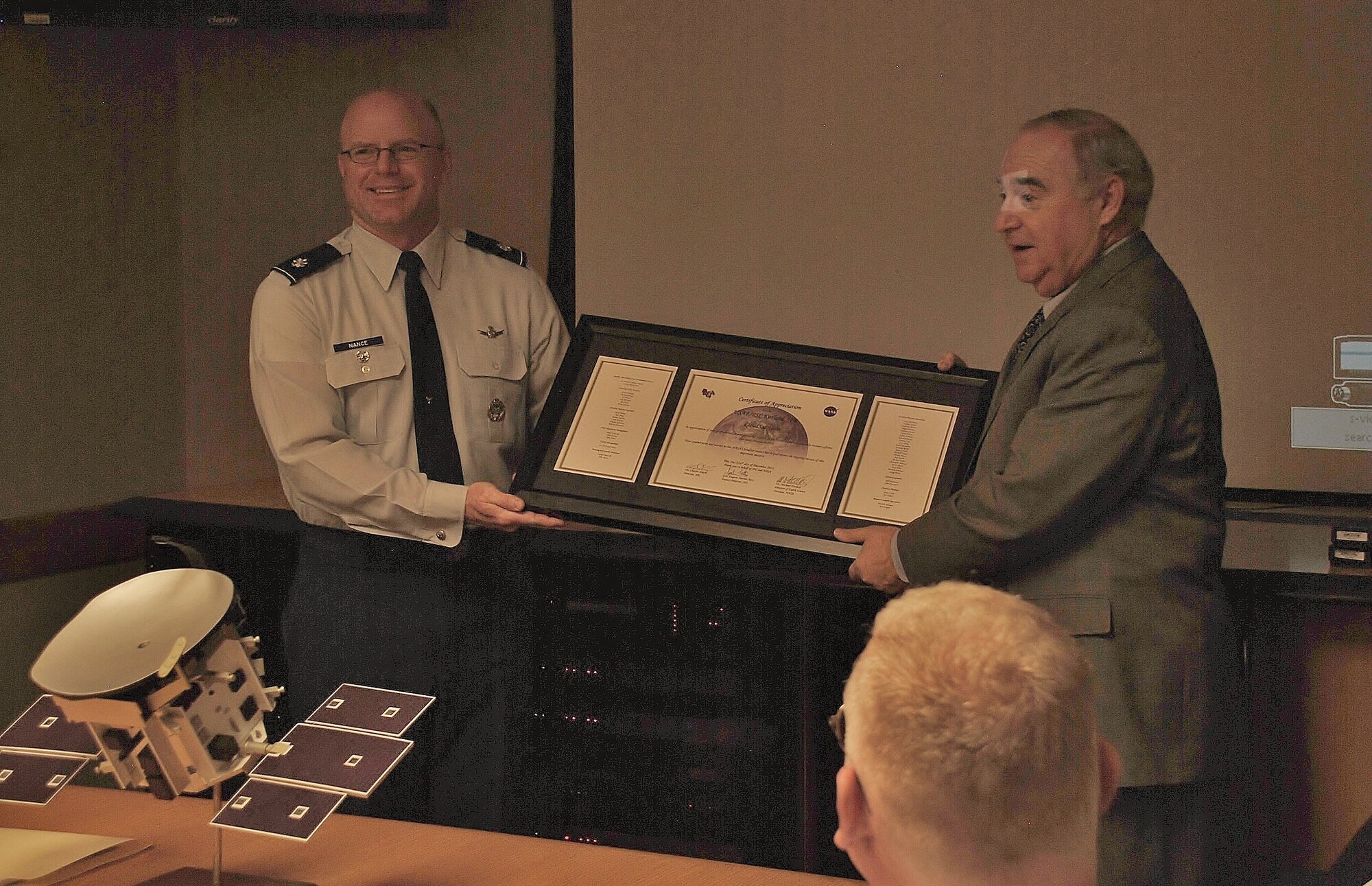 Lt. Col. Joseph Nance, Space Operations Branch chief, left, accepts the NASA certificate of appreciation on behalf of the CloudSat team from retired Lt. Gen. Gene Tattini.