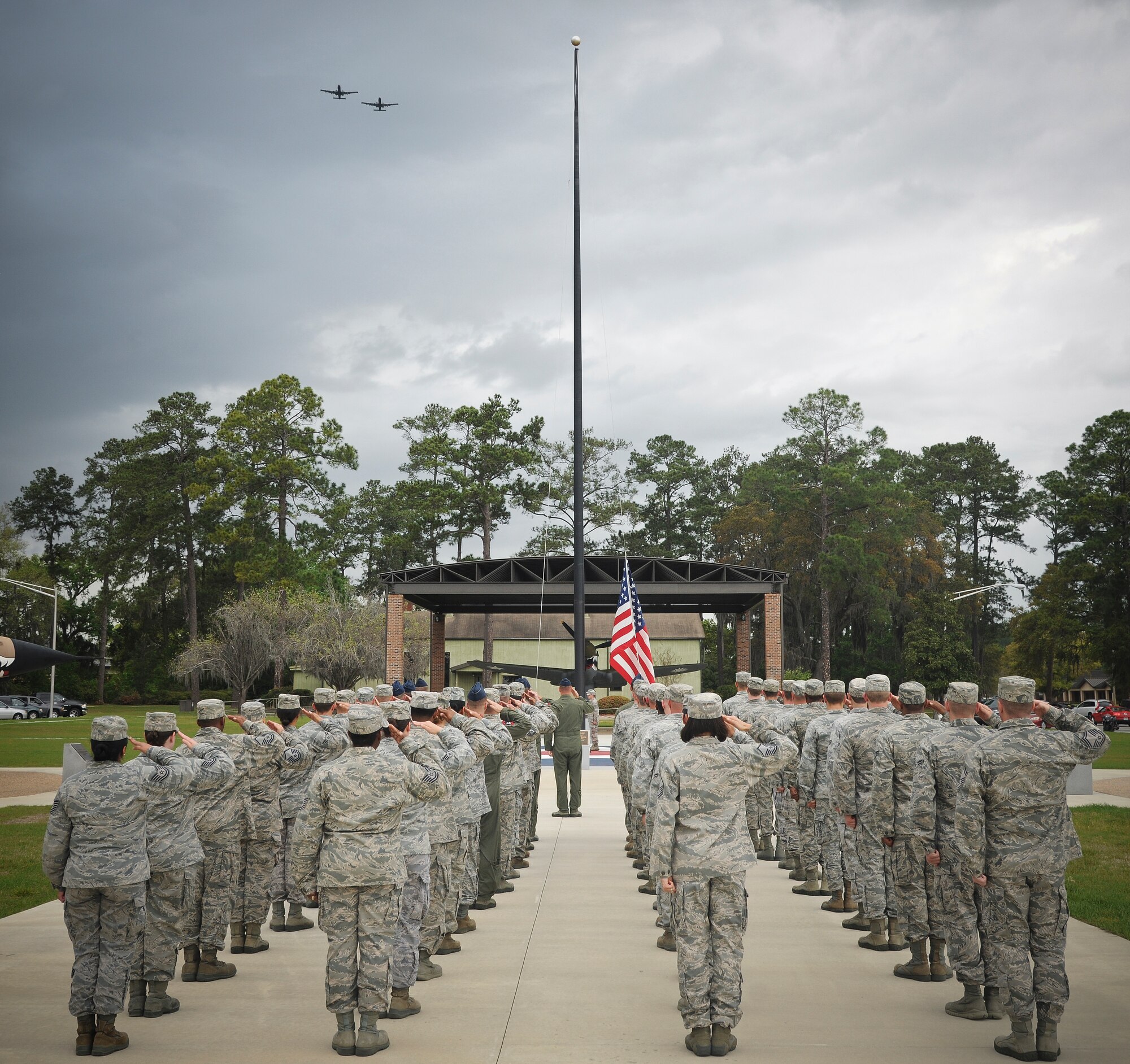 Airmen from the 23d Fighter Group salute the flag during a retreat ceremony at the President George W. Bush Air Park at Moody Field March 22, 2012, at Moody Air Force Base, Ga. Each month, members from different squadrons around the 23d Wing conduct the ceremony signaling the end of the official duty day. (U.S. Air Force photo by Airman 1st Class Paul Francis/Released)
