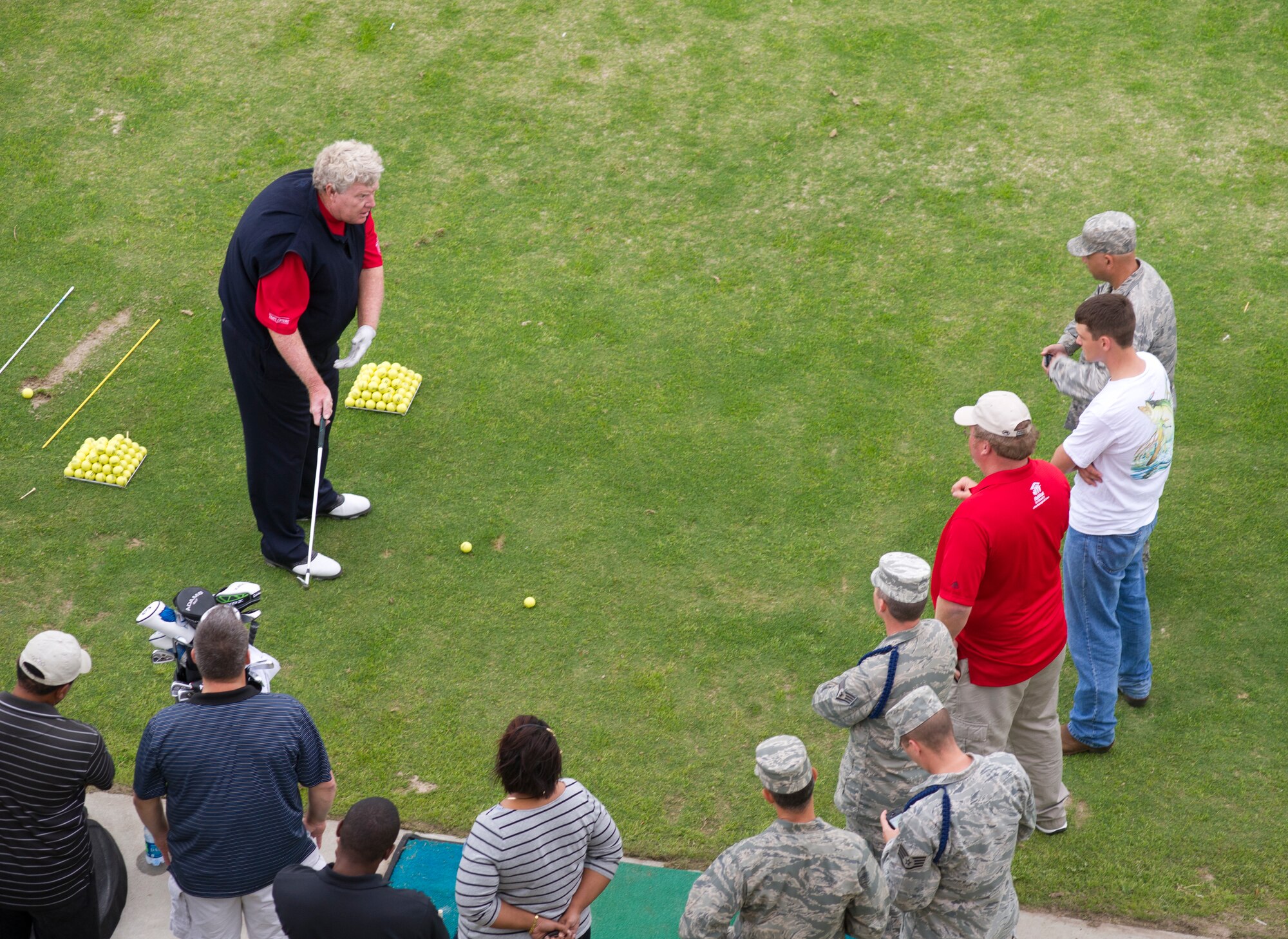 Pro golfer Andy Bean provides demonstrations illustrating how to solve golfing problems in response to audience members’ questions during a free clinic with pro golfer Larry Mize at the Bay Breeze Event Center March 21, 2012, at Keesler Air Force Base, Miss.  (U.S. Air Force photo by Adam Bond)