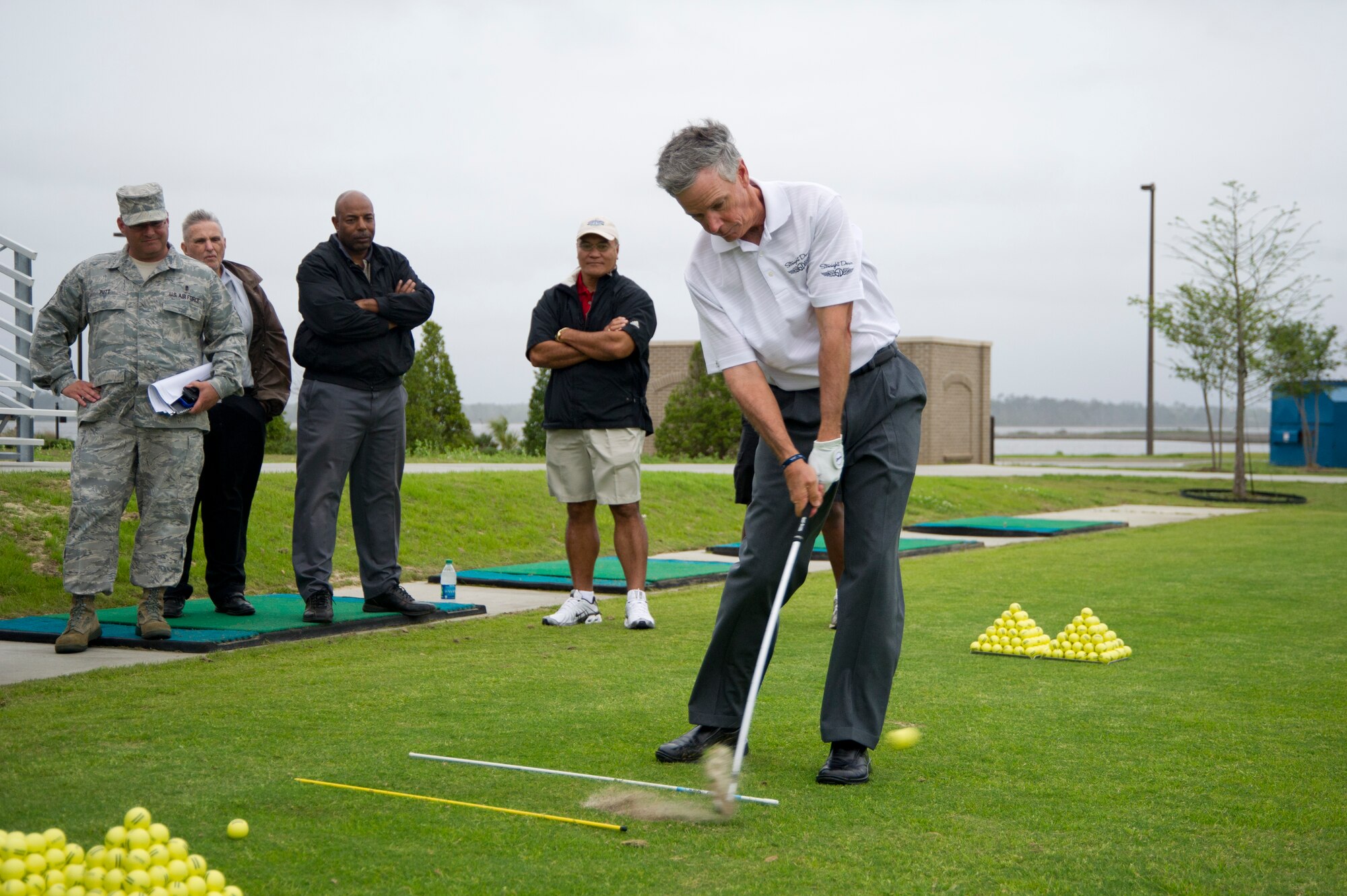 Pro golfer Larry Mize provides demonstrations illustrating how to solve golfing problems in response to audience members’ questions during a free clinic with pro golfer Andy Bean at the Bay Breeze Event Center March 21, 2012, at Keesler Air Force Base, Miss.  (U.S. Air Force photo by Adam Bond)