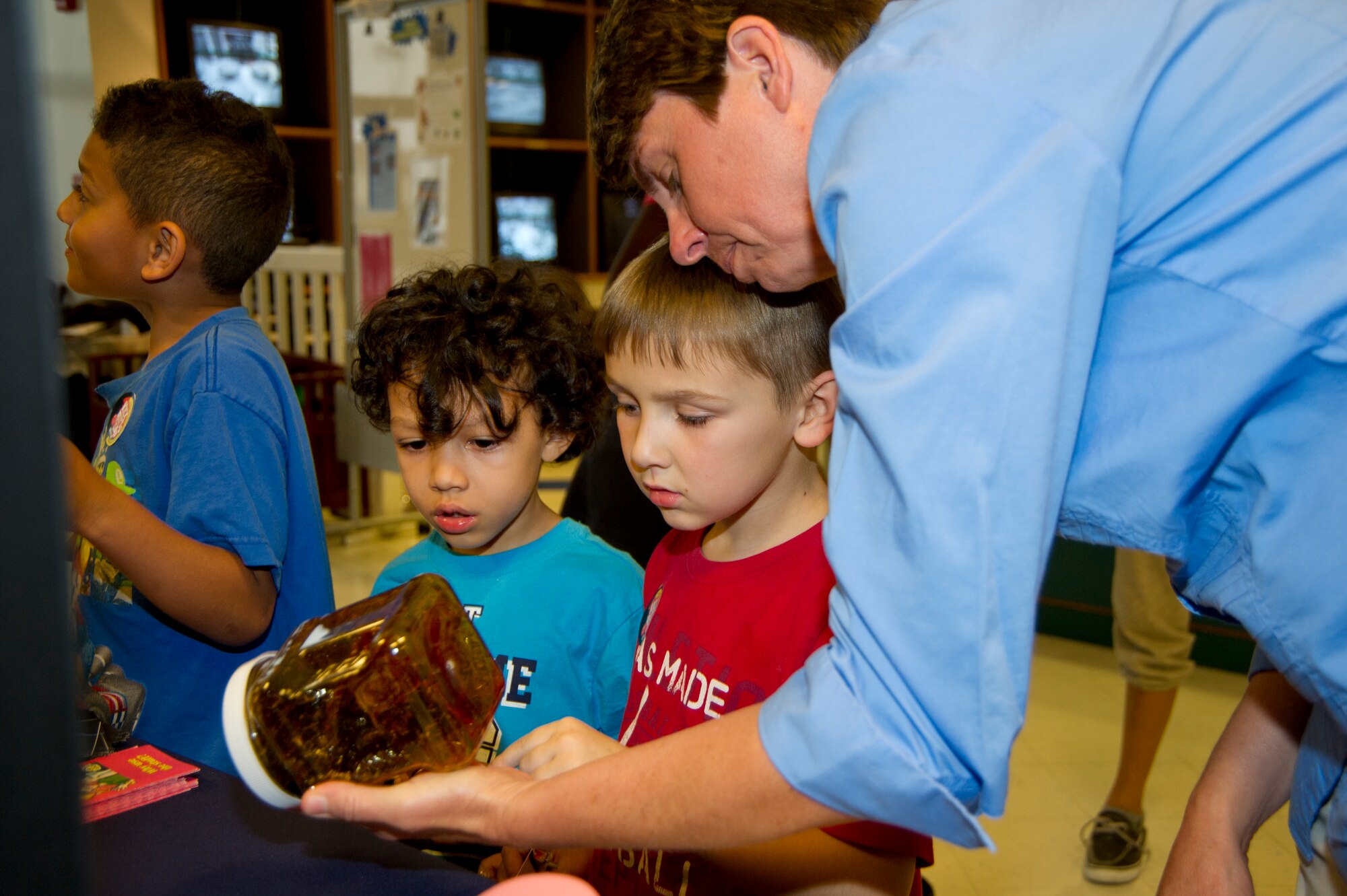 Koah Tigler-Liechty, 5, and Trevor Schritter, 6, get a firsthand look at a year’s worth of cigarette tar at the youth center March 21, 2012, with the help of Teri Jordan, 81st Aerospace Medicine Squadron, Keesler Air Force Base, Miss. The exhibit is part of Kick Butts Day, an anti-smoking event. Trevor’s mother is Natasha Wosyk, 81st Force Support Squadron.  Koah’s parents are Joshua Liechty and Staff Sgt. Metia Tigler, 81 Medical Operations Squadron.  (U.S. Air Force photo by Adam Bond)