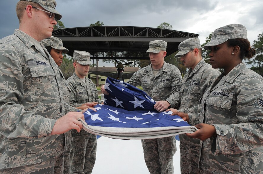 Members of Team Moody fold the flag during a retreat ceremony at the President George W. Bush Air Park at Moody Field March 22, 2012 at Moody Air Force Base, Ga. Col. Ronald Stuewe, 23d Fighter Group commander, applauded the unit’s participation in the event and encouraged them to keep up their efforts throughout the upcoming operational readiness inspection. (U.S. Air Force photo by Airman 1st Class Olivia Dominique/Released)