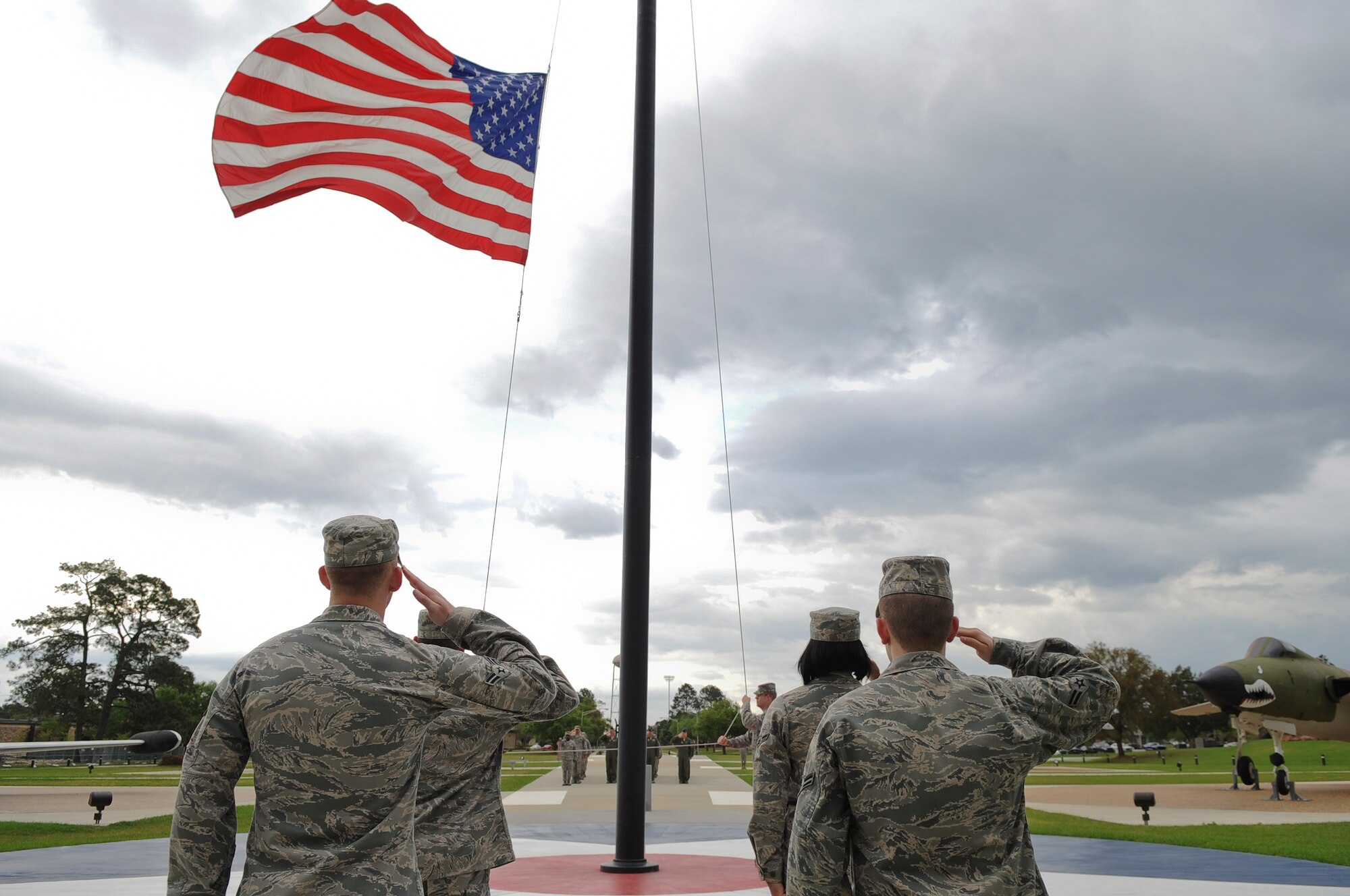 Airmen from the 74th Fighter Squadron and 23d Operations Support Squadron salute the flag during a retreat ceremony held at the President George W. Bush Air Park at Moody Field March 22, 2012, at Moody Air Force Base, Ga. Each month, members from different squadrons around the 23d Wing conduct the ceremony signaling the end of the official duty day.  (U.S. Air Force photo by Airman 1st Class Olivia Dominique/Released)
