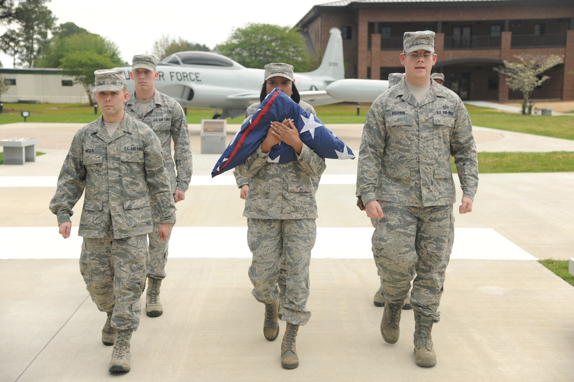 Team Moody members retire the flag during a retreat ceremony at the President George W. Bush Air Park at Moody Field March 22, 2012, at Moody Air Force Base, Ga. The retreat ceremony signifies the end of the official duty day where participants pay respects to the American flag and nation. (U.S. Air Force photo by Airman 1st Class Paul Francis/Released)