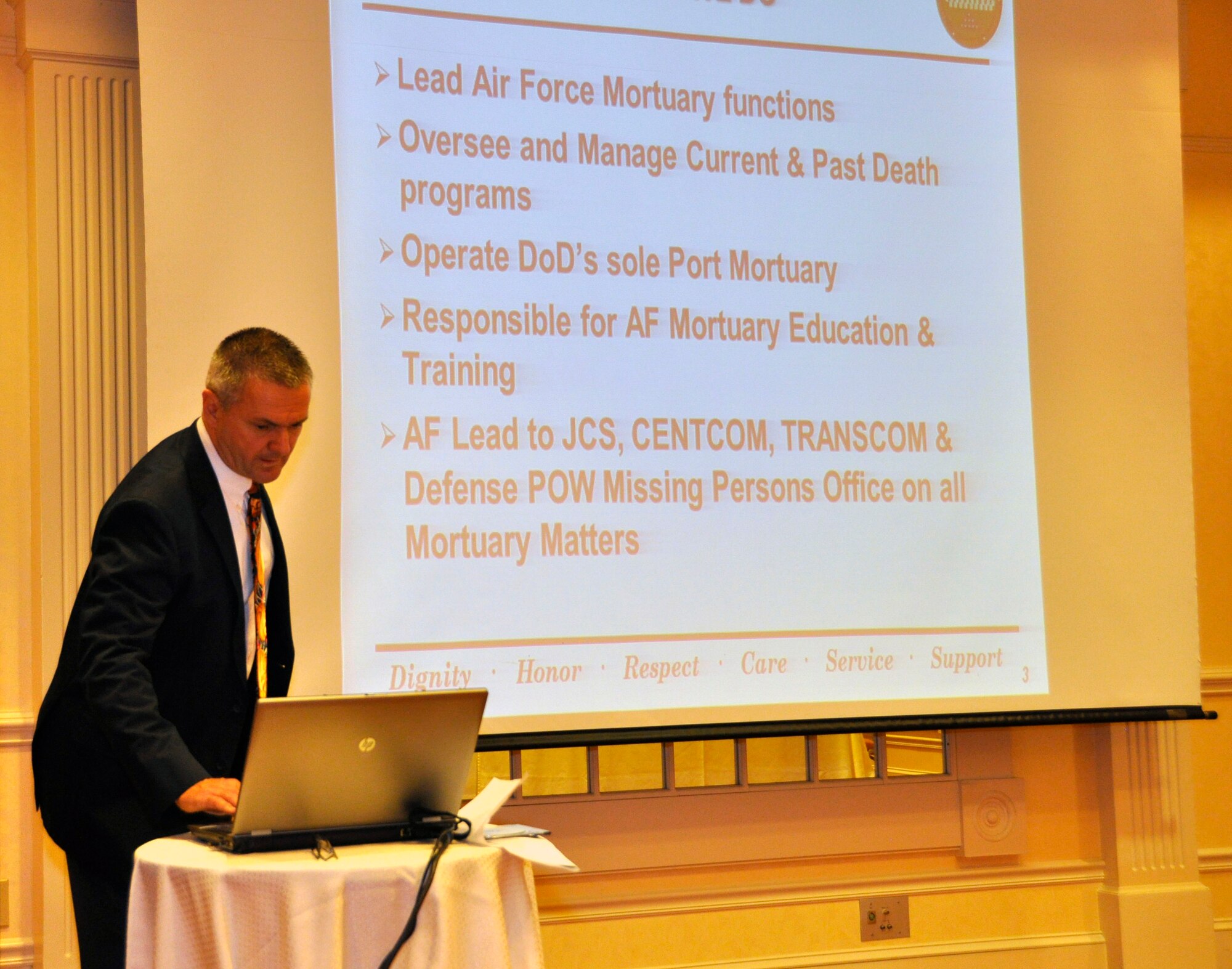 William Zwicharowski, Port Mortuary Branch chief at the Charles C. Carson Center for Mortuary Affairs, changes one of his slides March 22, 2012, at the Delaware State Funeral Directors Association 2012 Convention, held at the Sheraton Hotel in Dover. Zwicharowski briefed a group of about 30 funeral directors and associates about the Air Force Mortuary Affairs Operations mission and some of the techniques used at the Dover Port Mortuary. (U.S. Air Force photo/Lt. Col. Teresa Connor)