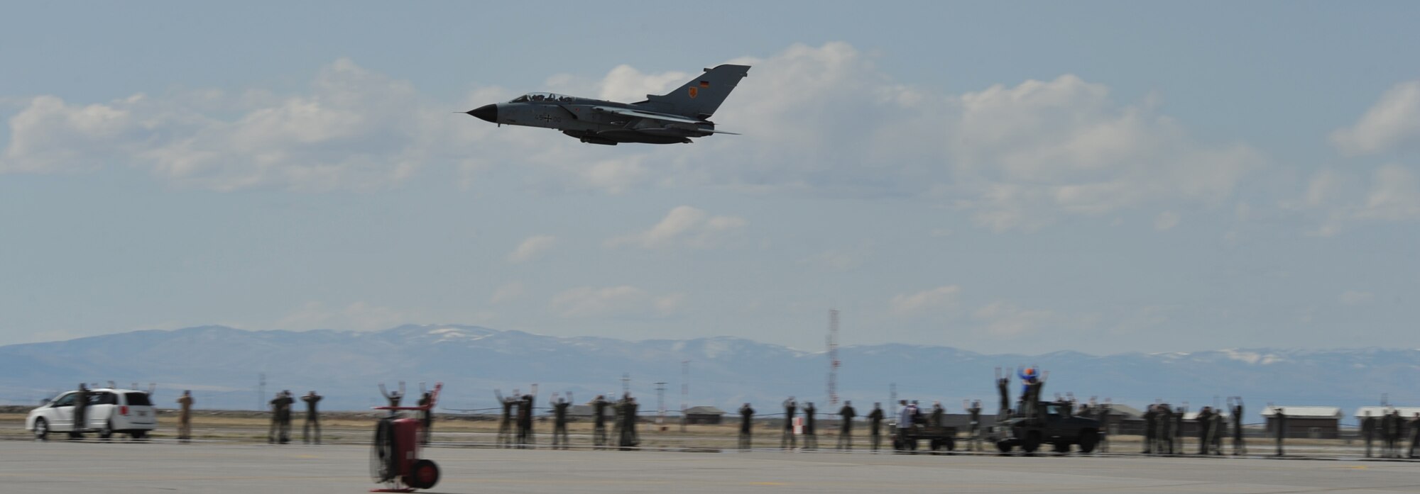 A German PA-200 Tornado flies over members of the German air force, March 22, 2012, at Mountain Home Air Force Base, Idaho. The decision for MHAFB to host such a large and diverse exercise is due to its extensive range complex that covers more than 187 square-miles of airspace in Idaho, Oregon and Nevada. (U.S. Air Force photo/Airman 1st Class Heather Hayward)